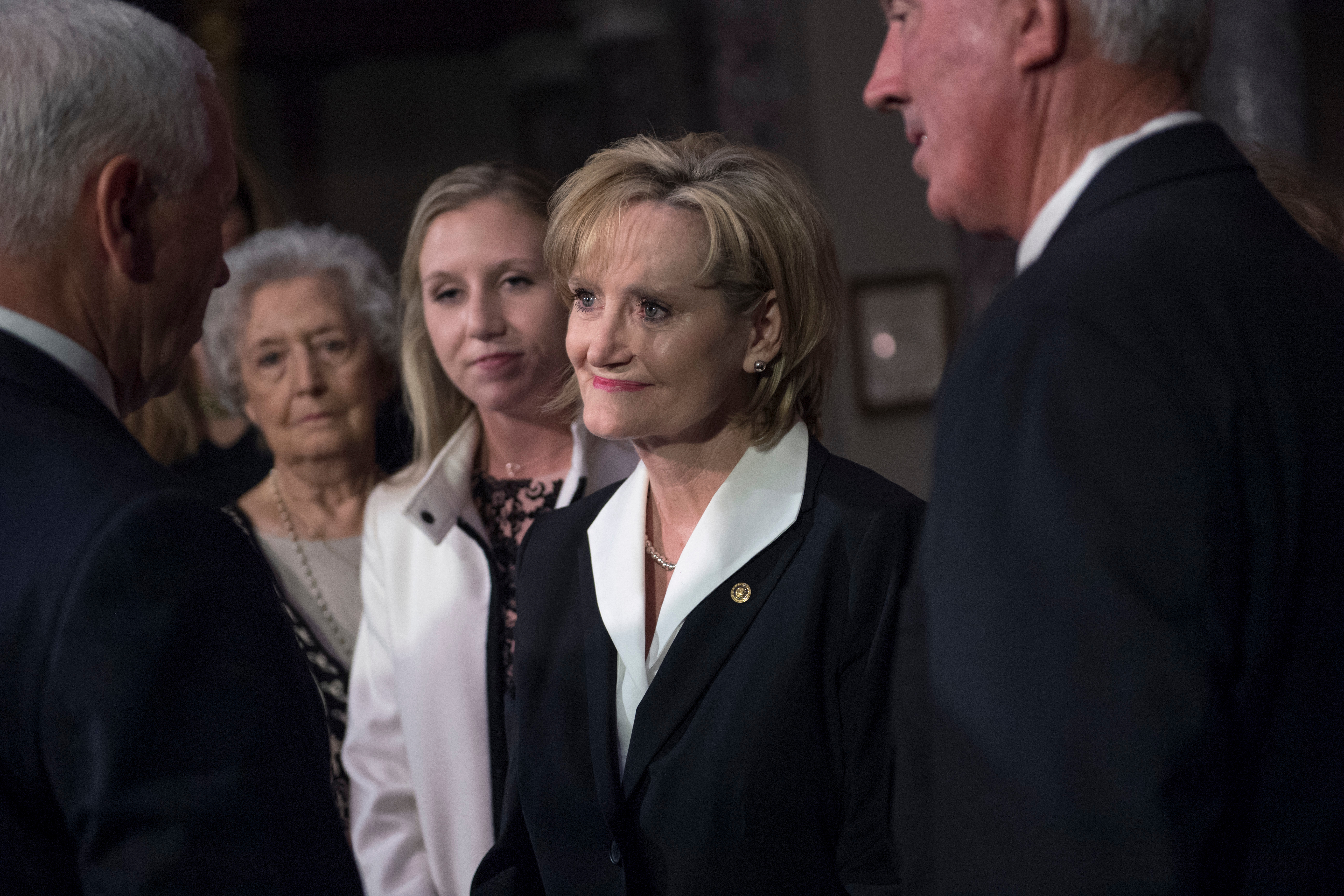 Sen. Cindy Hyde-Smith, R-Miss., talks with Vice President Mike Pence at her swearing-in ceremony in April. President Trump was in Mississippi Tuesday night to campaign for her. (Tom Williams/CQ Roll Call file photo)