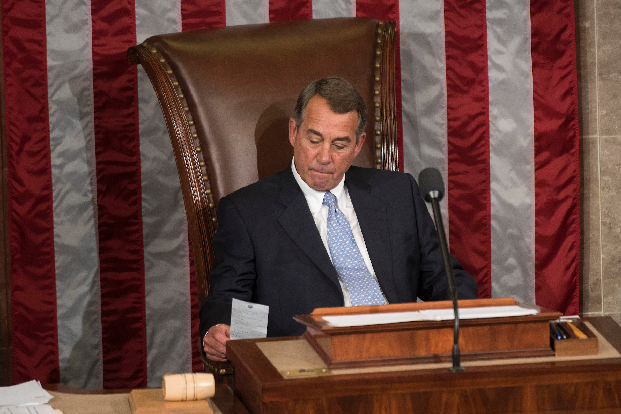 Outgoing Speaker John Boehner, R-Ohio, looks at his notes while waiting for a vote on the new Speaker in the House Chamber of the U.S. Capitol in Washington. (Drago/CQ Roll Call File Photo)