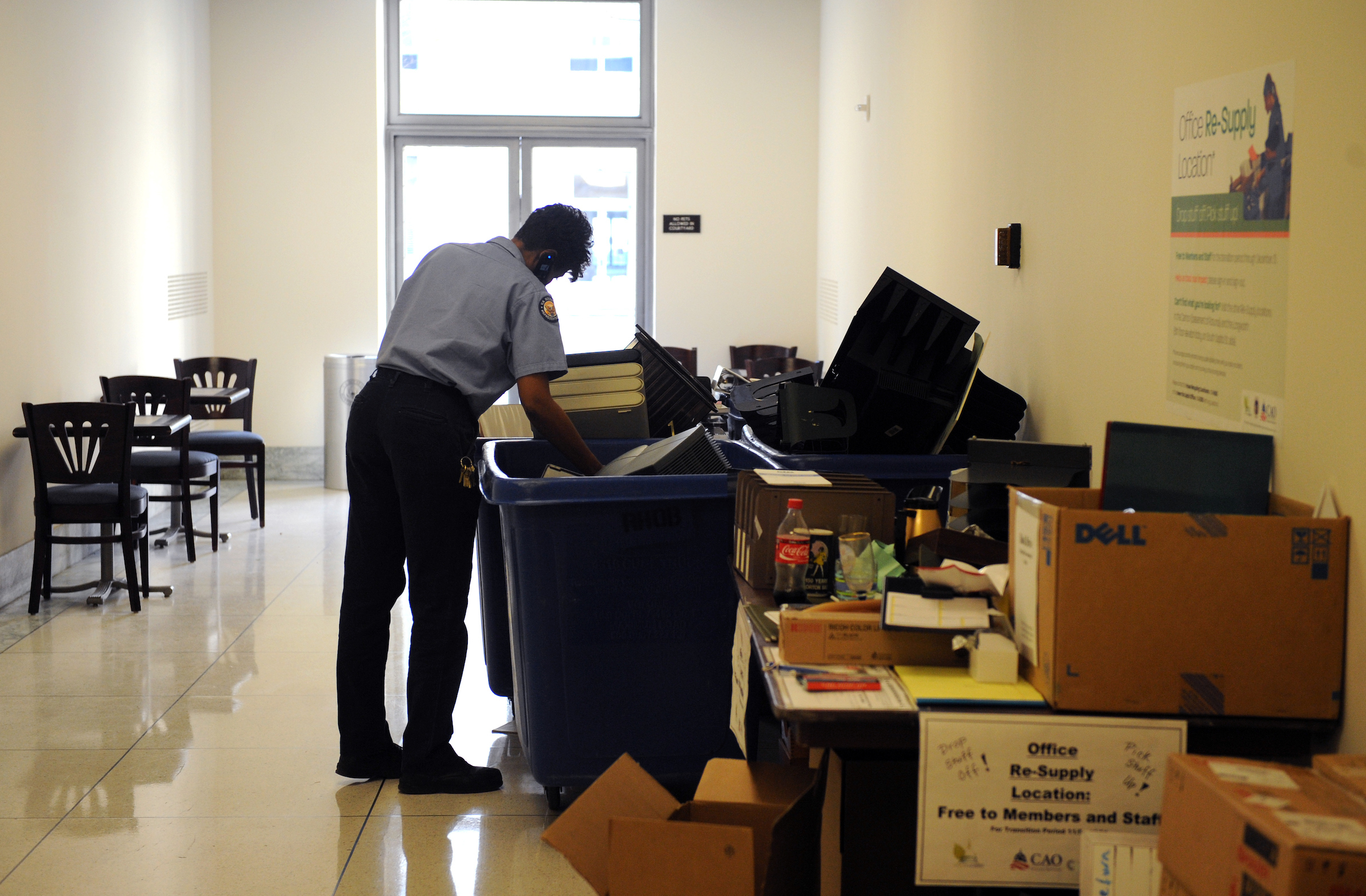 An Architect of the Capitol employee goes through supplies that are up for grabs at a drop site for discarded items from the office moving process, December 03, 2008.