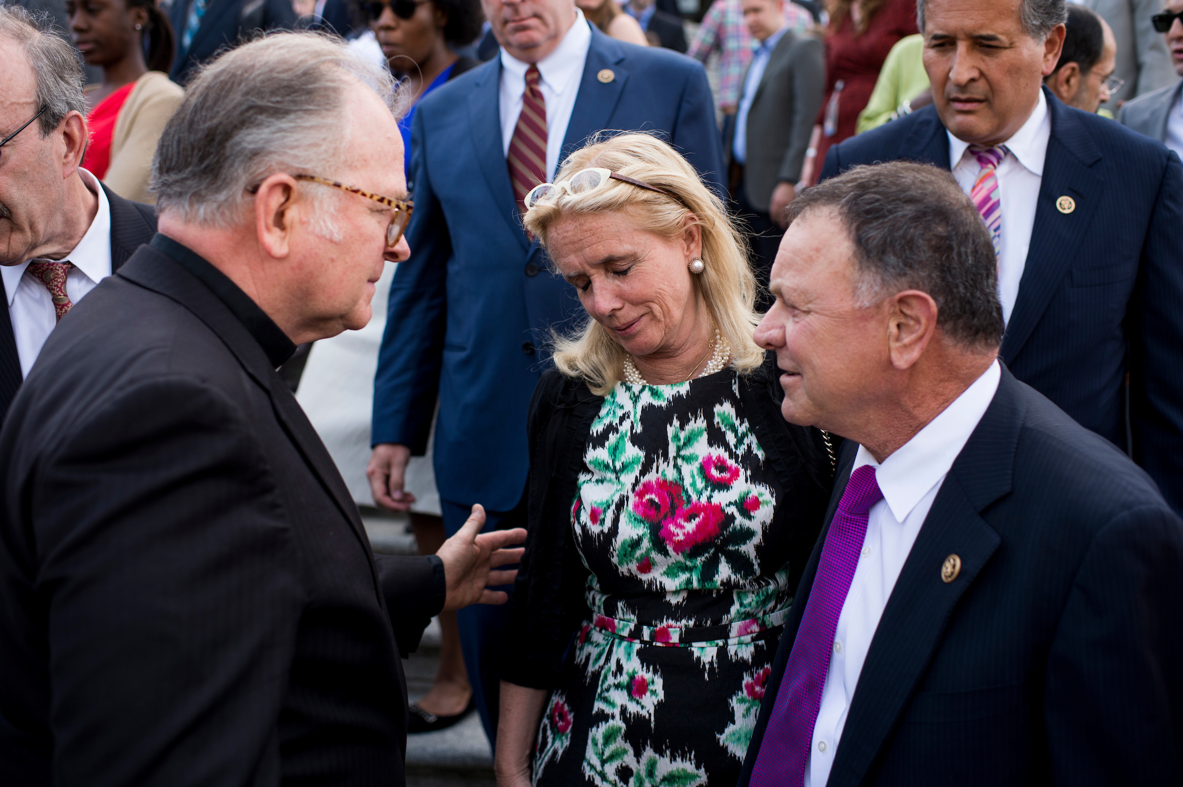 Father Patrick J. Conroy, left, consoles Rep. Debbie Dingell, D-Mich., center, as Rep. Richard Hanna, R-N.Y., looks on at the conclusion of a vigil and moment of silence on U.S. Capitol Steps on Monday, June 13, 2016, in remembrance of victims of the Orlando shooting. (Bill Clark/CQ Roll Call file photo)