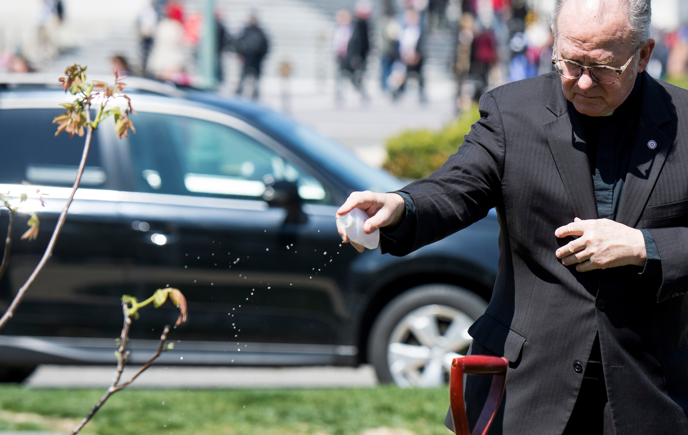 The Rev. Patrick J. Conroy, chaplain of the U.S. House of Representatives, blesses the walnut tree during a tree planting ceremony in memory of Rep. Louise Slaughter, D-N.Y., on April 18. (Bill Clark/CQ Roll Call file photo)