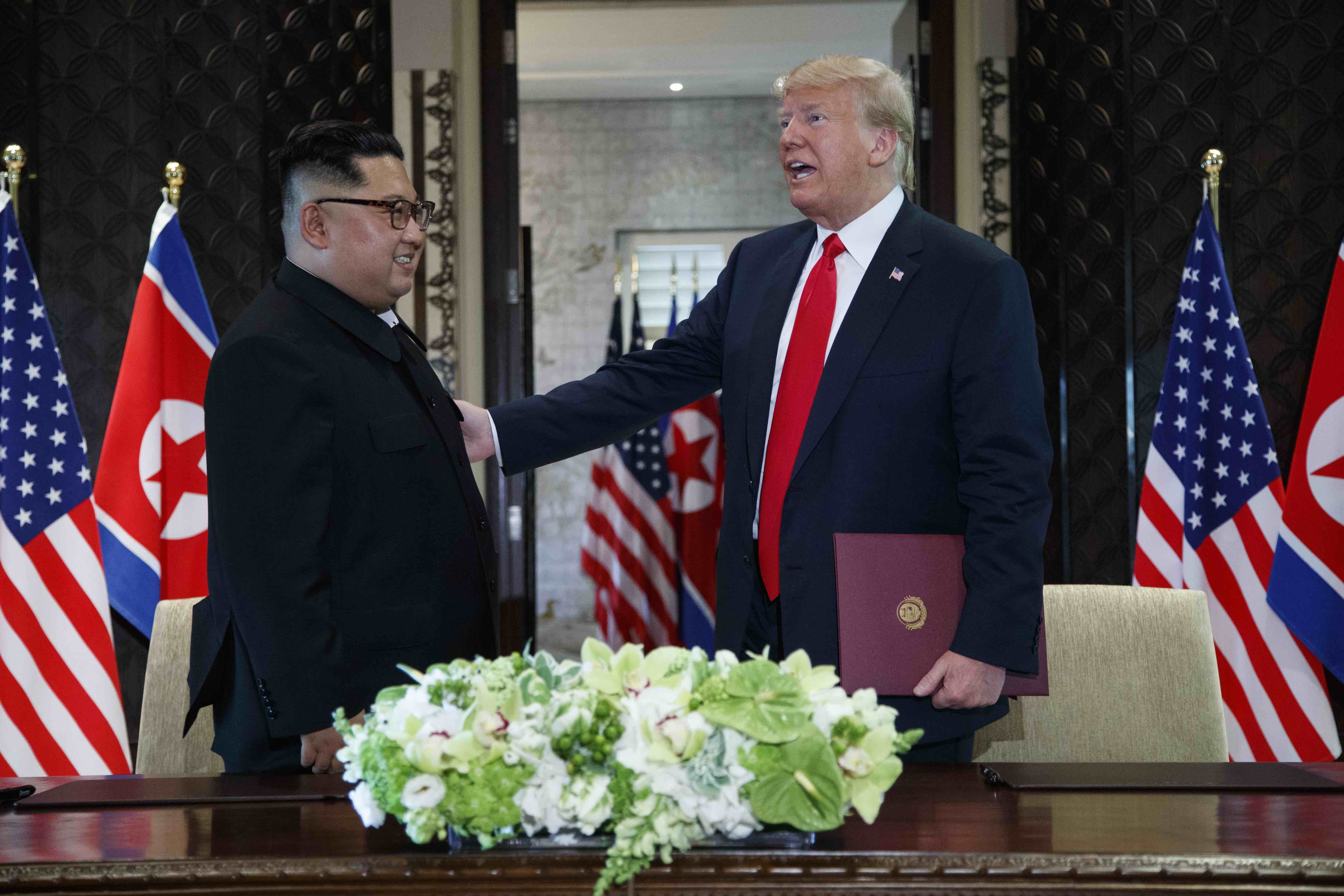 President Donald Trump and North Korean leader Kim Jong Un participate in a signing ceremony during a meeting on June 12 in Singapore. (AP Photo/Evan Vucci)