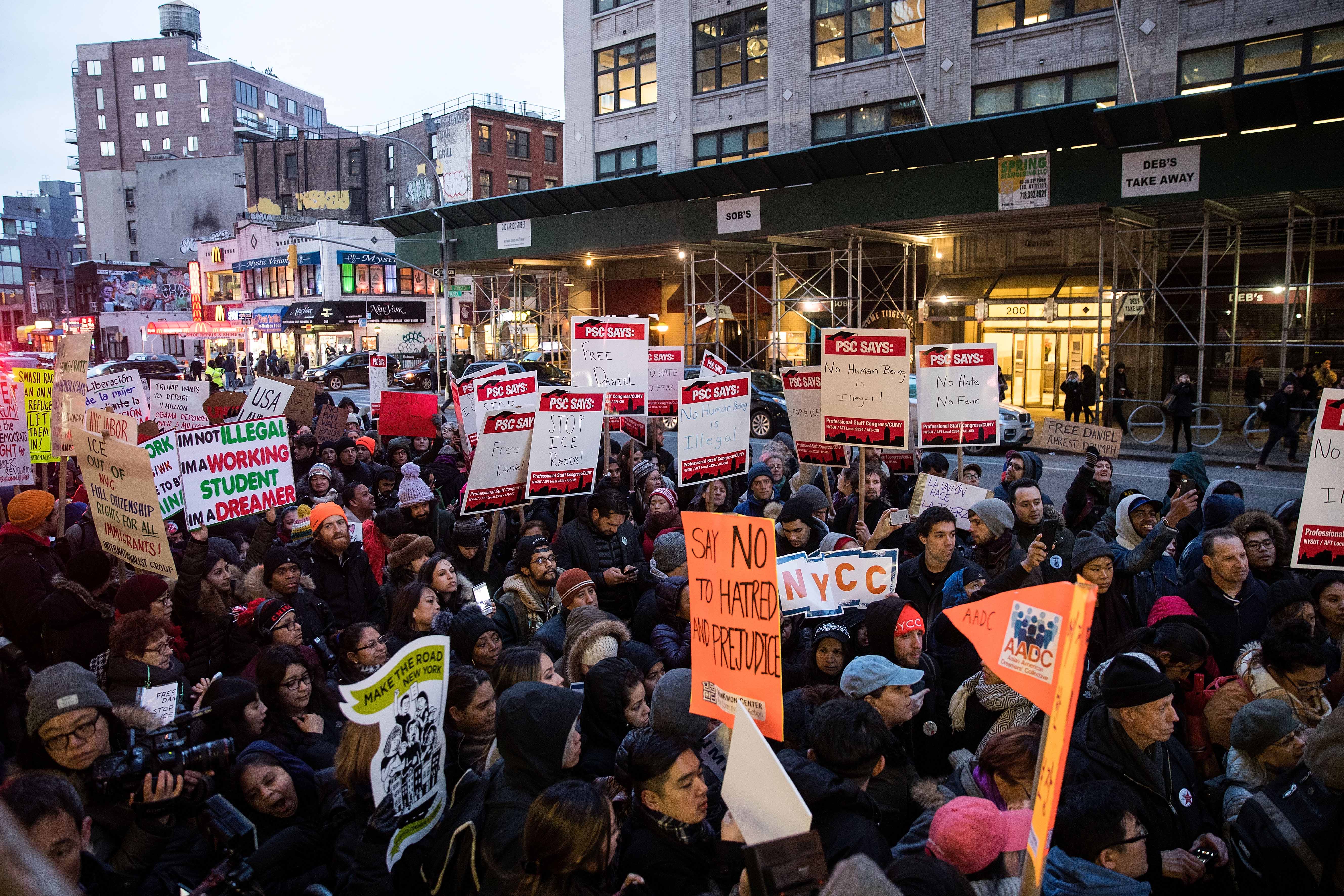 Immigrants and their supporters rally outside a federal immigration court in February 2017. With the government shutdown in full swing, most immigration courts are closed. (Drew Angerer/Getty Images file photo)