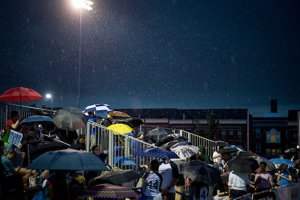 UNITED STATES - June 20: Fans watch in the rain as members of the press and congress play each other during the Congressional Women’s Softball Game at the Watkins Recreation Center in Capitol Hill Wednesday June 20, 2018. (Photo By Sarah Silbiger/CQ Roll Call)