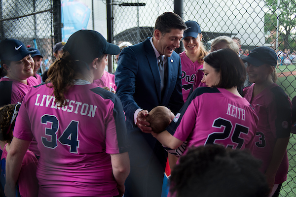 Speaker Paul D. Ryan visits with the press team, known as the Bad News Babes, at the Congressional Softball Game on Wednesday and meets 2-month-old Gibson, son of NPR's Tamara Keith. The Bad News Babes defeated Team Congress 5-0 in five innings before rain halted the game. (Sarah Silbiger/CQ Roll Call)