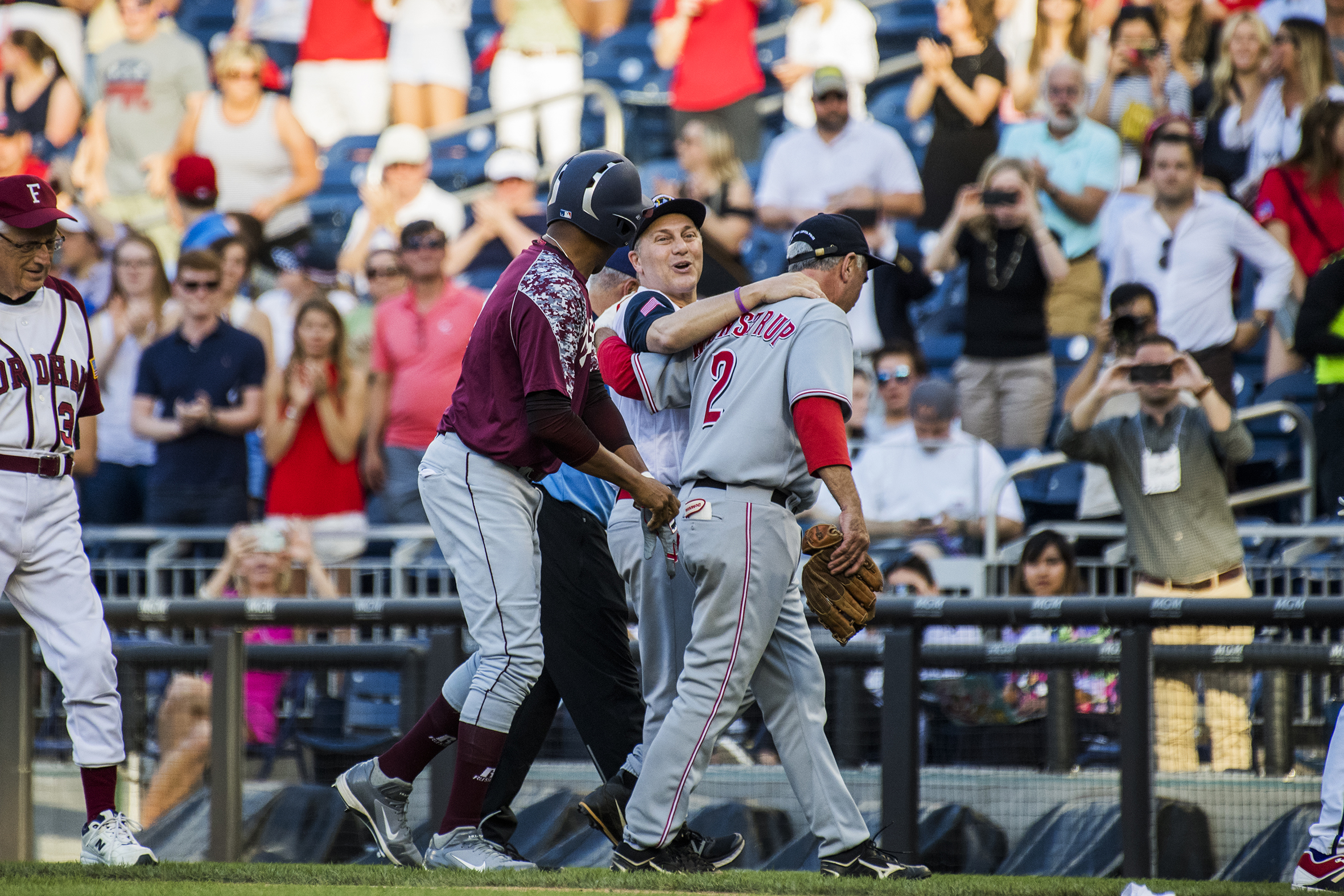House Majority Whip Steve Scalise, R- La., is helped off the field by teammates after throwing out the first runner of the night during the 57th annual Congressional Baseball Game at Nationals Park on June 14, 2018. Scalise was critically wounded in last year's Republican baseball practice shooting. (Photo By Tom Williams/CQ Roll Call)