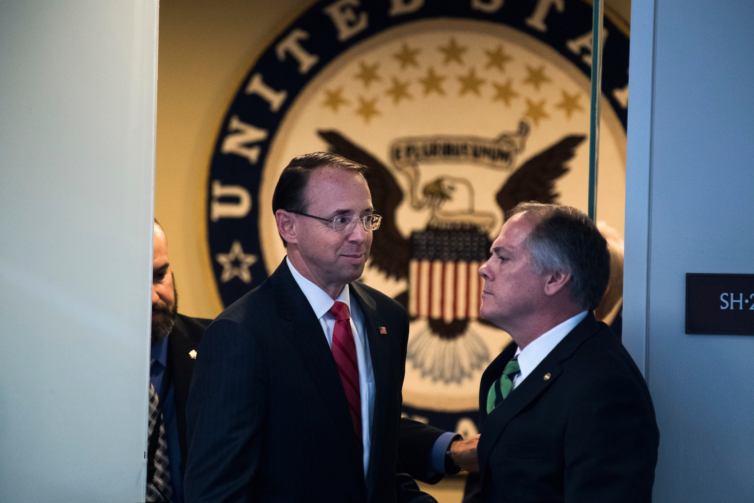 Deputy Attorney General Rod Rosenstein passes James Wolfe, Senate Intelligence Committee director of staff security, after a committee hearing in May 2017. (Tom Williams/CQ Roll Call file photo)