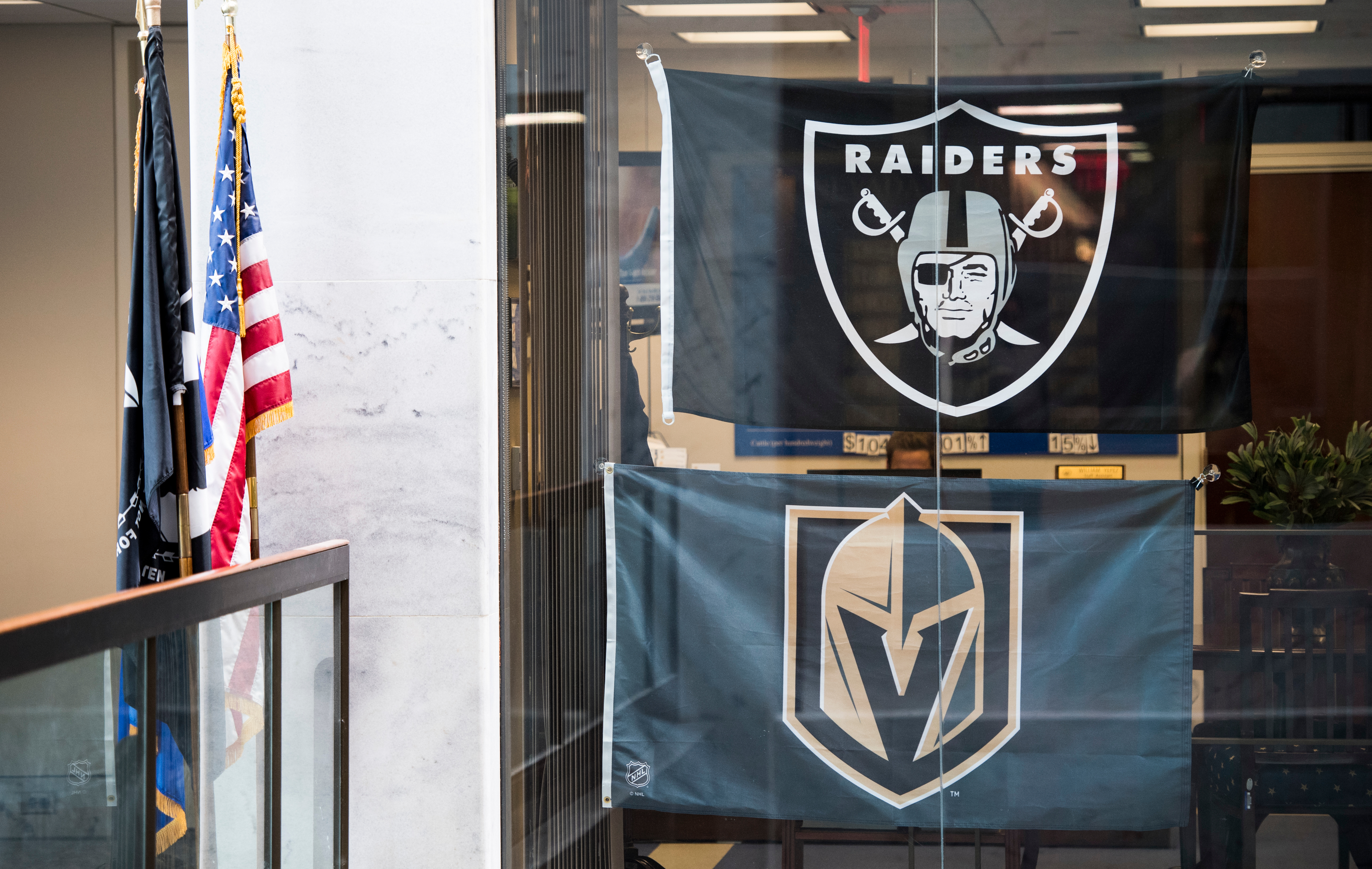 Flags of the Las Vegas Golden Knights and soon-to-be Las Vegas Raiders hang in Nevada Sen. Dean Heller’s office in the Hart Building on Monday. (Bill Clark/CQ Roll Call)