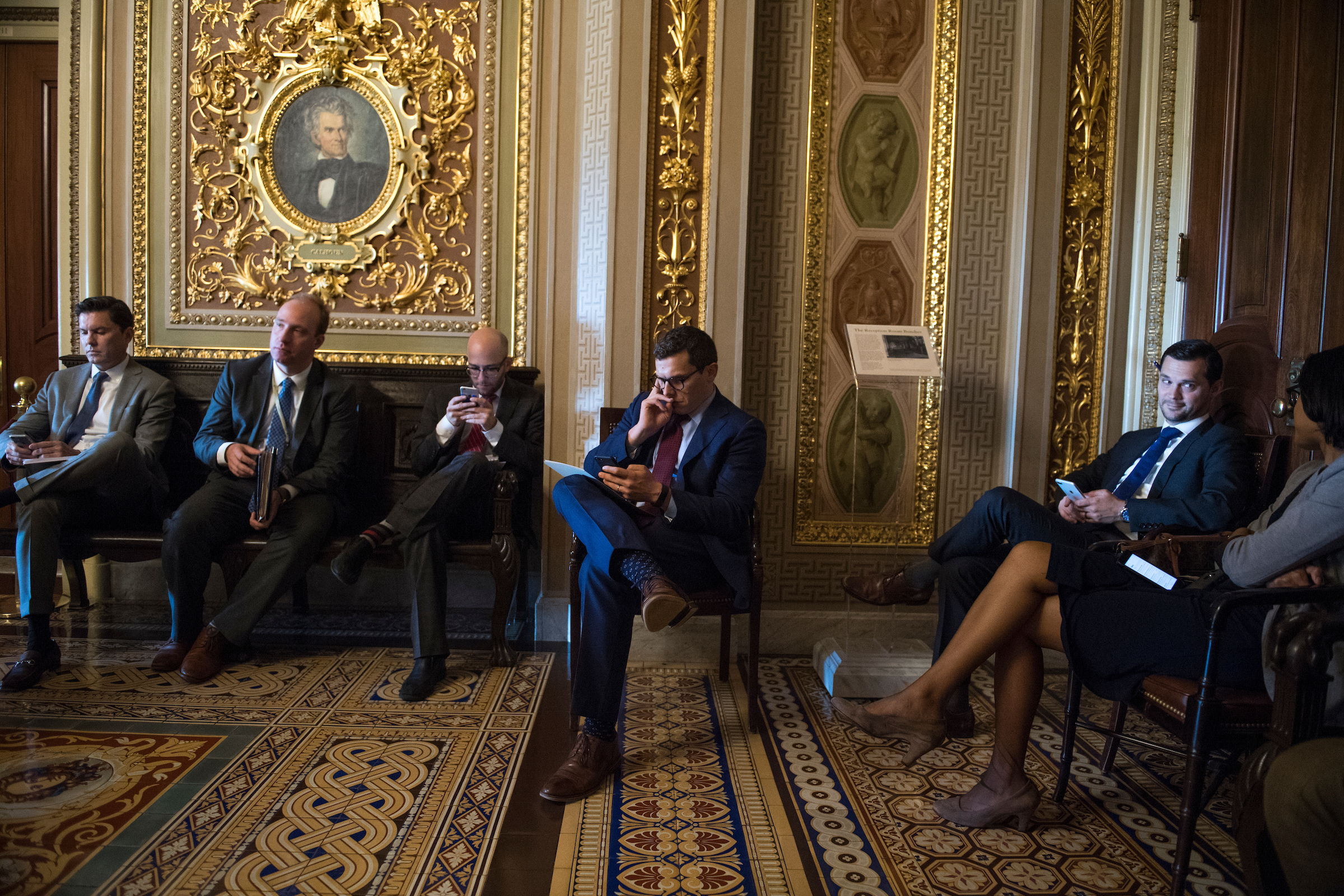 UNITED STATES - JUNE 5: Matt House, center, aide to Senate Minority Leader Charles Schumer, D-N.Y., waits for his boss in the Capitol's Senate Reception Room during the Senate Policy luncheons on June 5, 2018. (Photo By Tom Williams/CQ Roll Call)