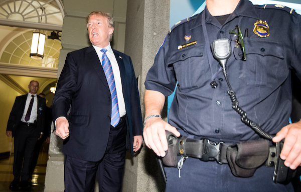 UNITED STATES - JUNE 19: President Donald Trump pauses to make a remark to the media as he arrives for the House Republican caucus meeting in the basement go the Capitol on Tuesday, June 19, 2018. (Photo By Bill Clark/CQ Roll Call)