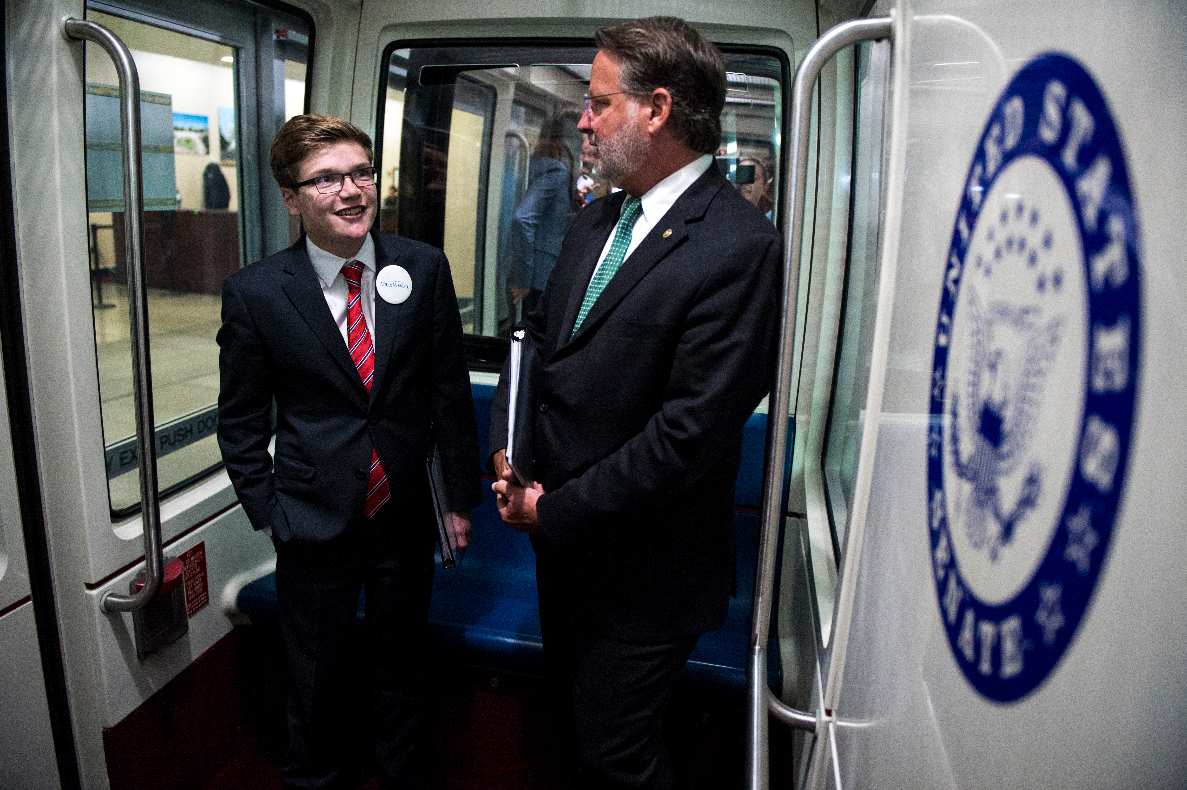 Make-A-Wish recipient and 'U.S. Senator For a Day' Thomas Stephenson and Sen. Gary Peters', D-Mich., ride the Senate Subway Tuesday July 10, 2018. (Photo by Sarah Silbiger/CQ Roll Call)