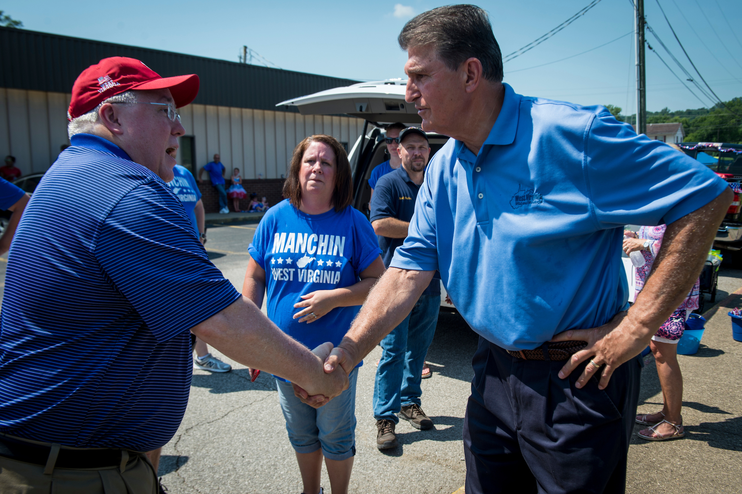 West Virginia Attorney General Patrick Morrisey, left, shakes hands with Sen. Joe Manchin III before the start of a Fourth of July parade in Ripley, W.Va. (Sarah Silbiger/CQ Roll Call)