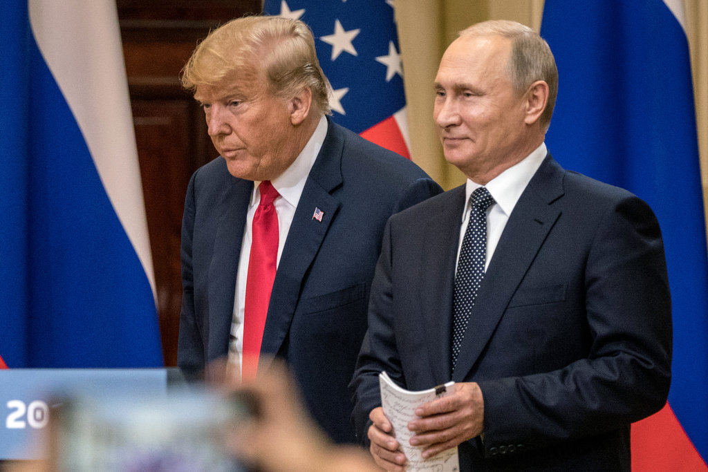 President Donald Trump and Russian President Vladimir Putin arrive for a joint press conference after their summit last month in Helsinki, Finland. (Chris McGrath/Getty Images)