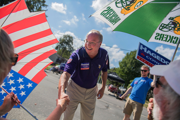 National Republicans are hoping the strong economy will boost candidates like Jim Hagedorn, their nominee in Minnesota’s 1st District, seen here campaigning Sunday at the Applefest parade in La Crescent, Minn. However, public polling shows the economy is not at the top of voters’ concerns. (Tom Williams/CQ Roll Call)