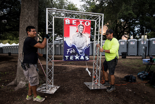 Workers move a neon Beto sign into place before the start of Democratic candidate for U.S. Senate from Texas Rep. Beto O'Rourke's Turn out For Texas Rally, featuring a concert by Wille Nelson, in Austin, Texas on Saturday, Sept. 29, 2018. (Photo By Bill Clark/CQ Roll Call)
