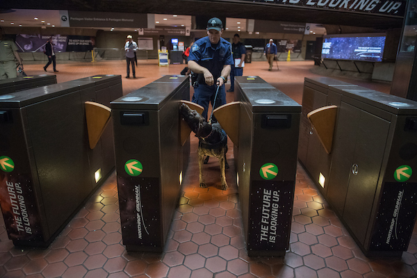 UNITED STATES - SEPTEMBER 11: A Metro Transit Police Department officer and a K-9 dog conduct a security sweep at the Pentagon Metro stop on September 11, 2018. (Photo By Tom Williams/CQ Roll Call)