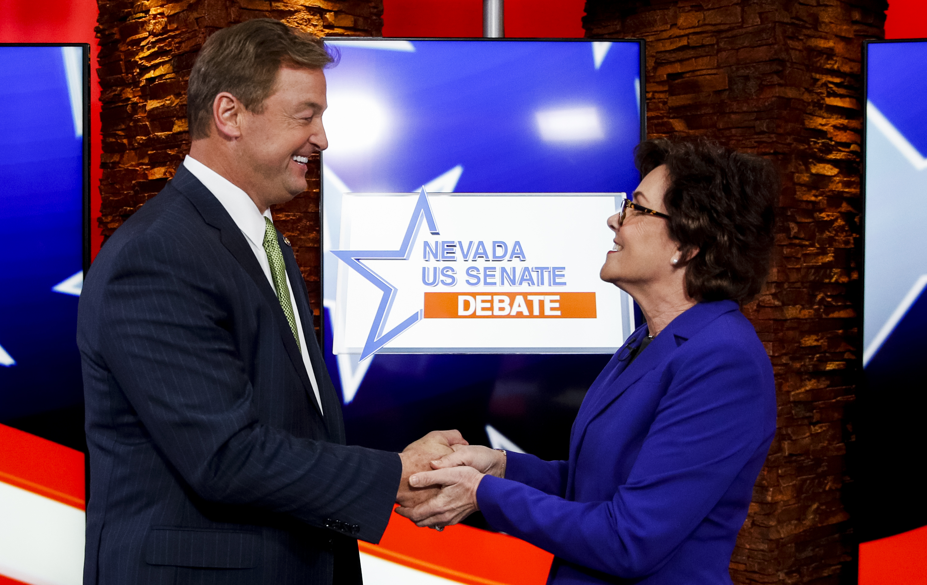 UNITED STATES - OCTOBER 19: Sen. Dean Heller, R-Nev., and his challenger Rep. Jacky Rosen, D-Nev., shake hands before the start of the Nevada U.S. Senate debate at KLAS-TV in Las Vegas on Friday, Oct. 19, 2018. (AP Photo/John Locher/POOL)