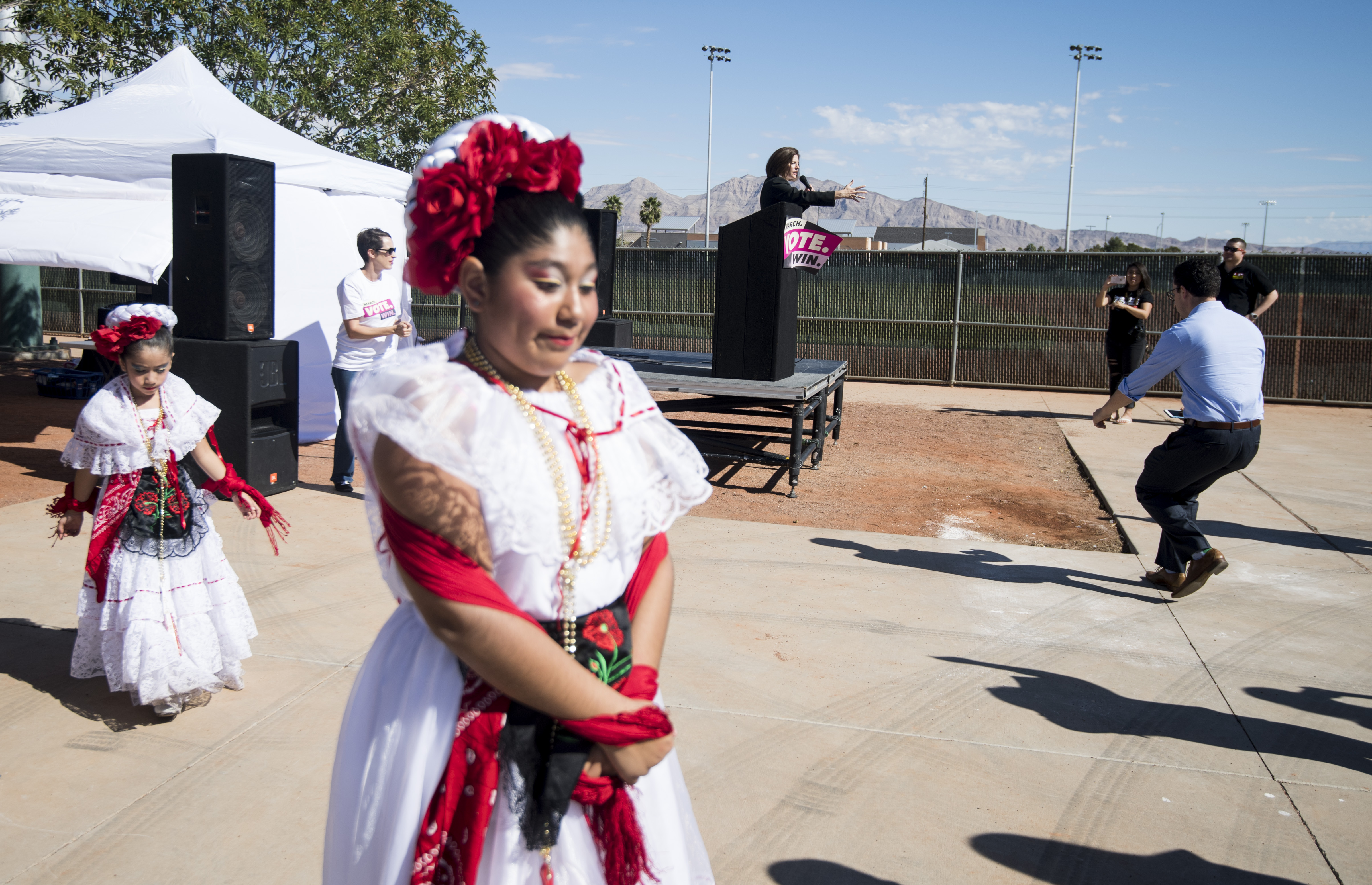 Sen. Catherine Cortez Masto, D-Nev., speaks on stage as dancers with the Mexico Vivo group prepares to perform at the East Las Vegas Community Center, an early voting location, in Las Vegas on Saturday, Oct. 20, 2018, the first day of early voting in Nevada. (Photo By Bill Clark/CQ Roll Call)