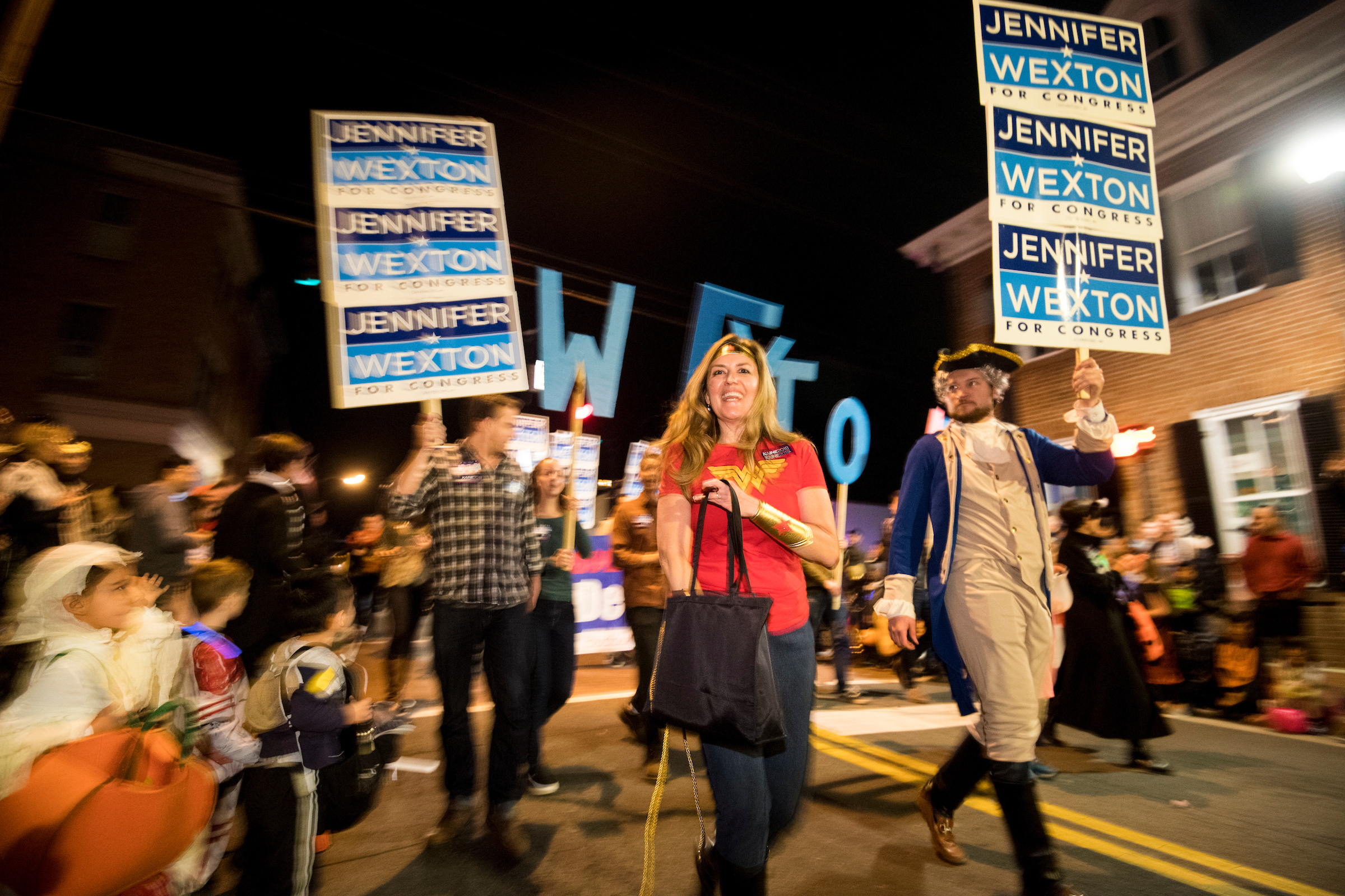 UNITED STATES - OCTOBER 31: Jennifer Wexton, the Democrat challenging Rep. Barabra Comostock in Virginia's 10th district, hands out candy to kids during the 62nd Annual Kiwanis Halloween Parade in Leesburg, Va., on Wednesday, Oct. 31, 2018. (Photo By Bill Clark/CQ Roll Call)