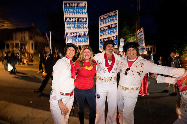 UNITED STATES - OCTOBER 31: Jennifer Wexton, the Democrat challenging Rep. Barabra Comostock in Virginia's 10th district, stops for a photo with a group of supporters dressed up as Elvis during the 62nd Annual Kiwanis Halloween Parade in Leesburg, Va., on Wednesday, Oct. 31, 2018. (Photo By Bill Clark/CQ Roll Call)