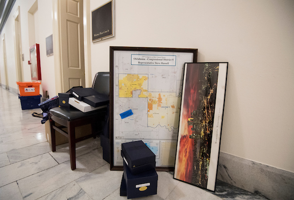 UNITED STATES - NOVEMBER 30: The map for Rep. Steve Russell's district on Oklahoma sits next to a framed photo of the Minneapolis skyline in the Cannon House Office Building as members move out of their offices on Friday, Nov. 30, 2018. (Photo By Bill Clark/CQ Roll Call)