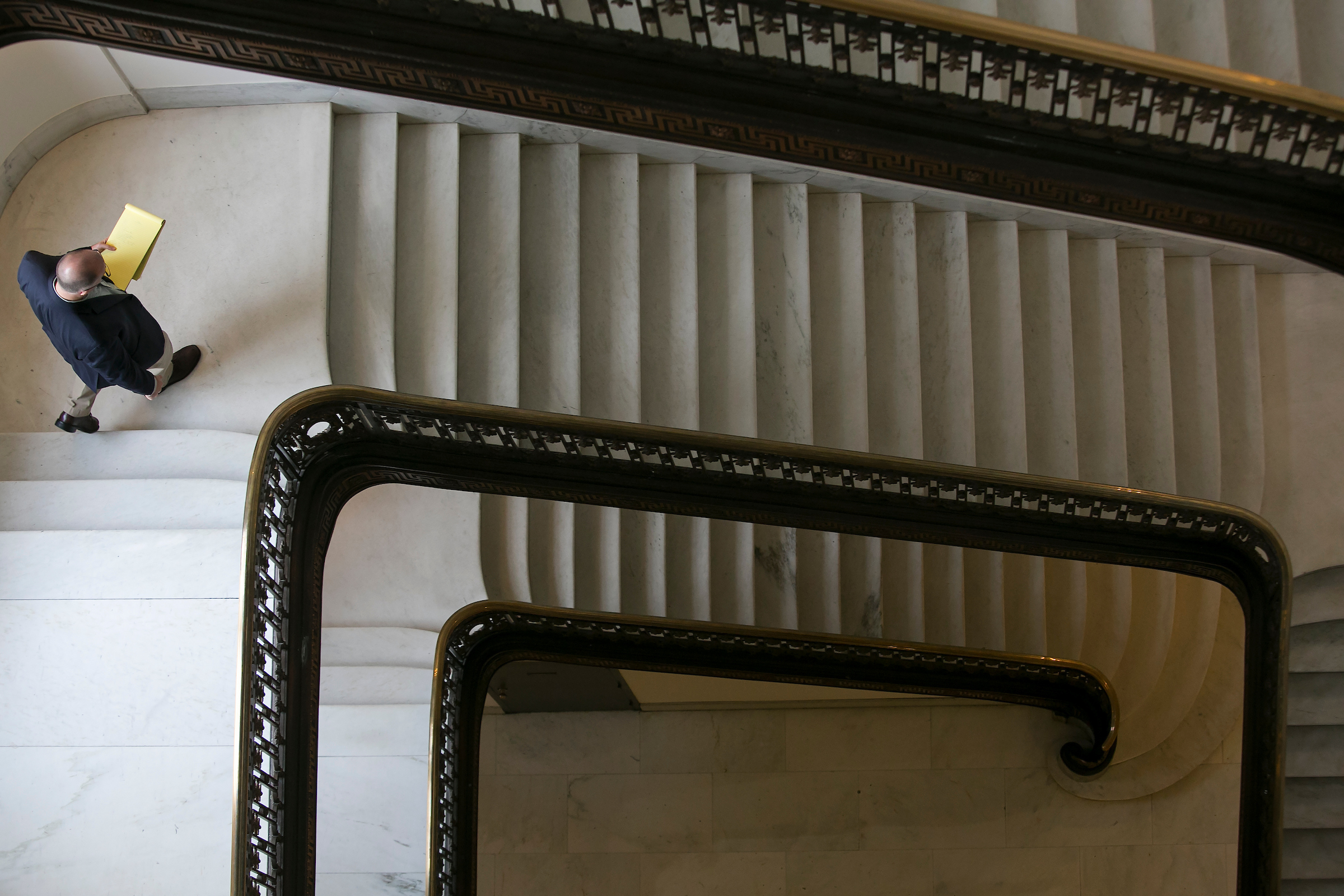 UNITED STATES - August 6: A congressional staffer heads down the stairs of the Russell Senate Office Building on Capitol Hill in Washington, Thursday, August 6, 2015. Congress is in recess until September 8. (Photo By Al Drago/CQ Roll Call)