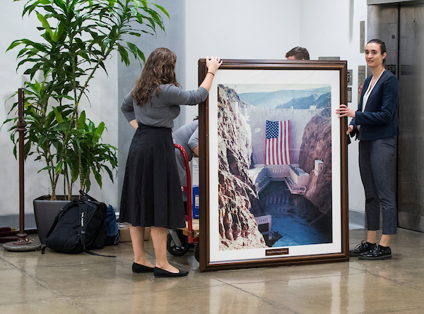 Rep. Jacky Rosen, D-Nev., staffers load a framed photo of the Hoover Dam and other items onto a hand cart as they make their way to her new office in the Dirksen Senate Office building on Tuesday, Nov. 27, 2018. Rep. Rosen will be Nevada's new junio Senator after defeating Sen. Dean Heller, R-Nev. (Photo By Bill Clark/CQ Roll Call)