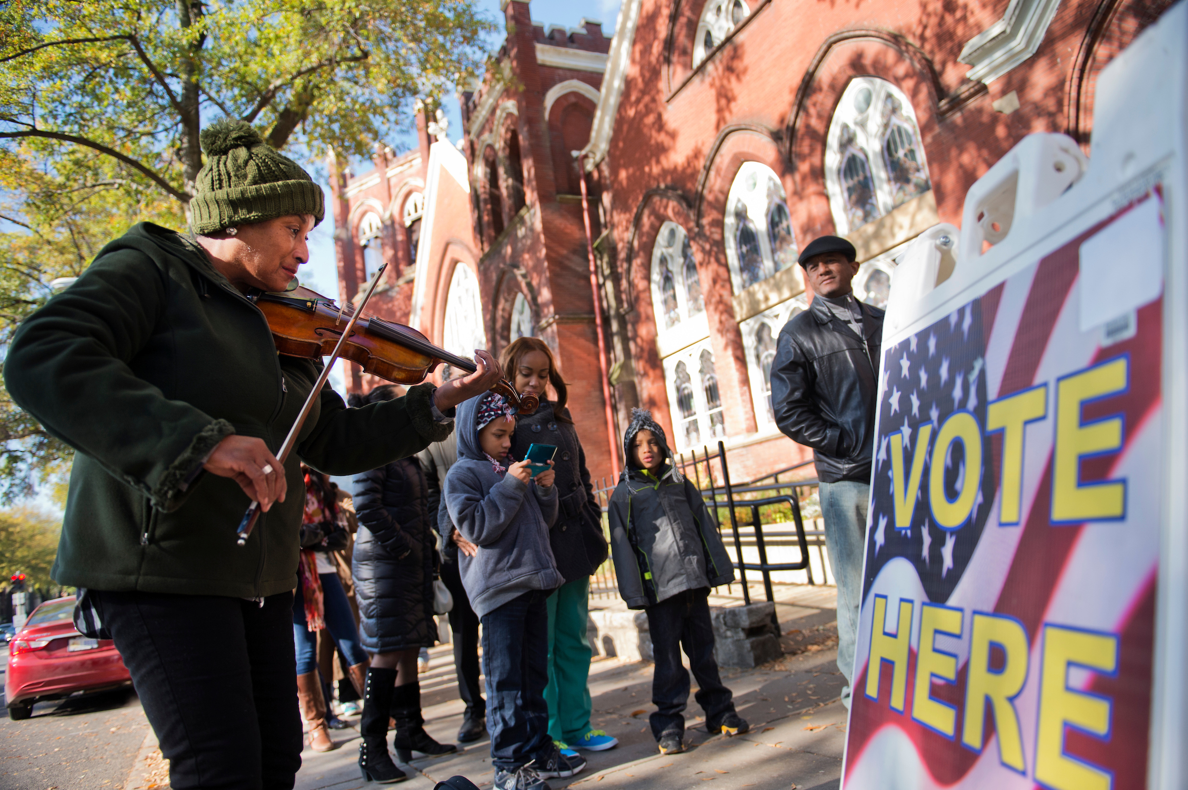 Voters gather outside a polling place in D.C. in 2016. In rough political seas, democracy can serve as ballast, Grumet writes. (Tom Williams/CQ Roll Call file photo)