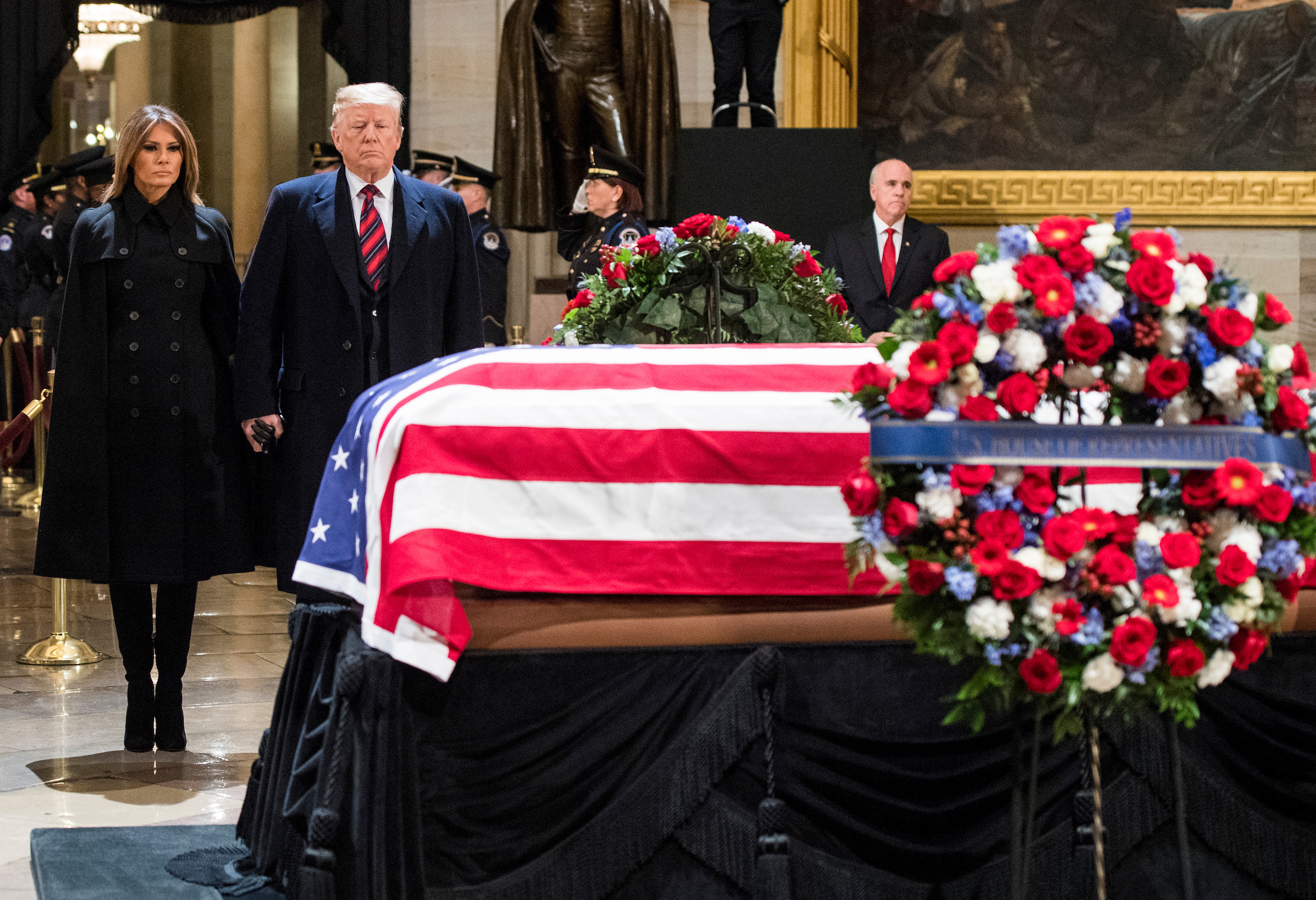 President Donald Trump and first lady Melania Trump pay their respect at former President George H.W. Bush's casket in the Capitol Rotunda on Monday night. (Bill Clark/CQ Roll Call)