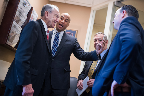 From left, Sens. Charles E. Grassley, R-Iowa, Cory Booker, D-N.J., Richard J. Durbin, D-Ill., and Mike Lee, R-Utah, make a social media post before a news conference in the Capitol on the passage of the criminal justice reform bill, the First Step Act, on Wednesday. (Tom Williams/CQ Roll Call)