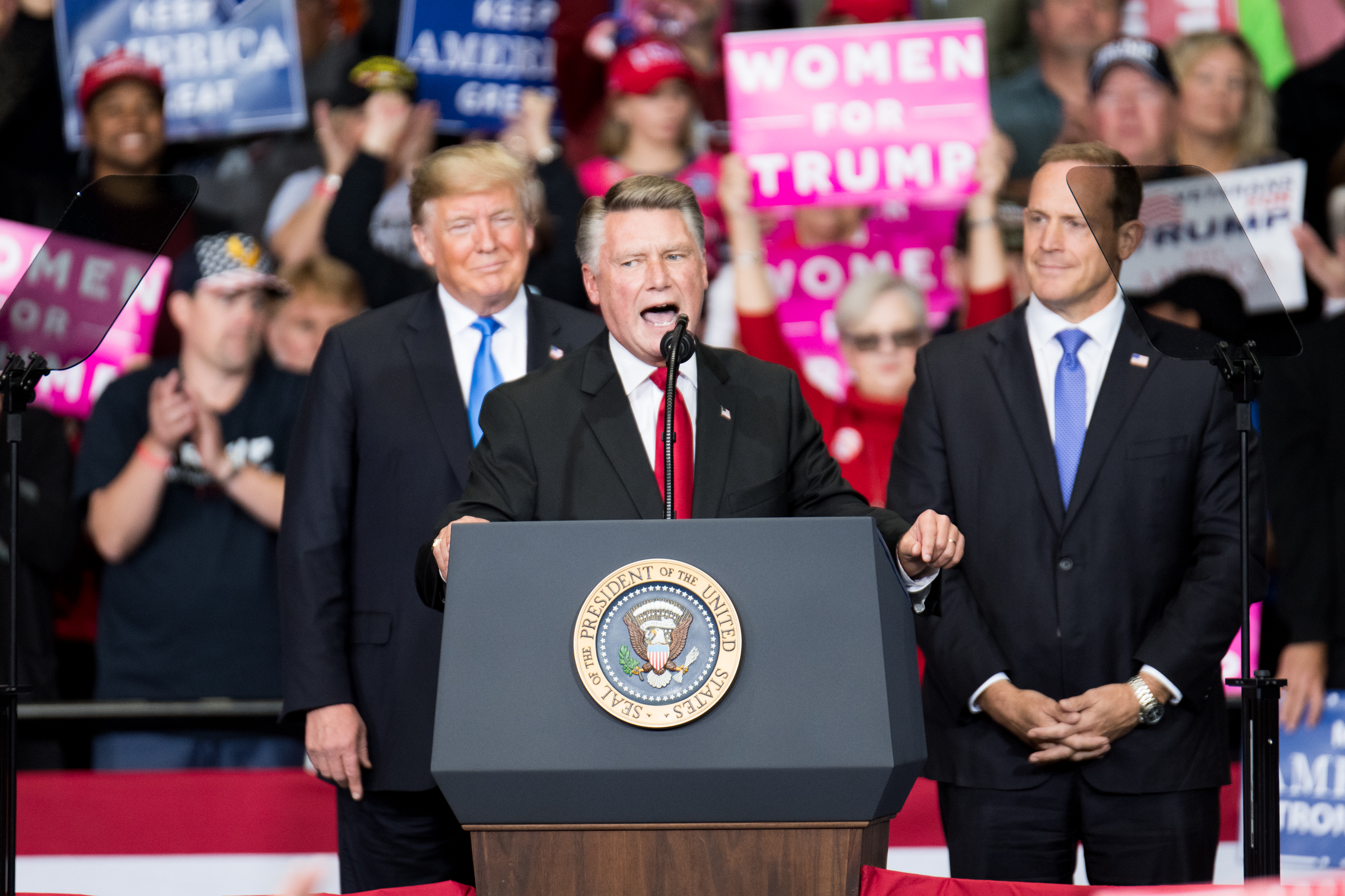 Republican Mark Harris, center, announced on Tuesday that he won’t run in the special election for North Carolina’s 9th District. Above, Harris campaigns in Charlotte, N.C., in October 2018 with President Donald Trump and Rep. Ted Budd. (Sean Rayford/Getty Images file photo)