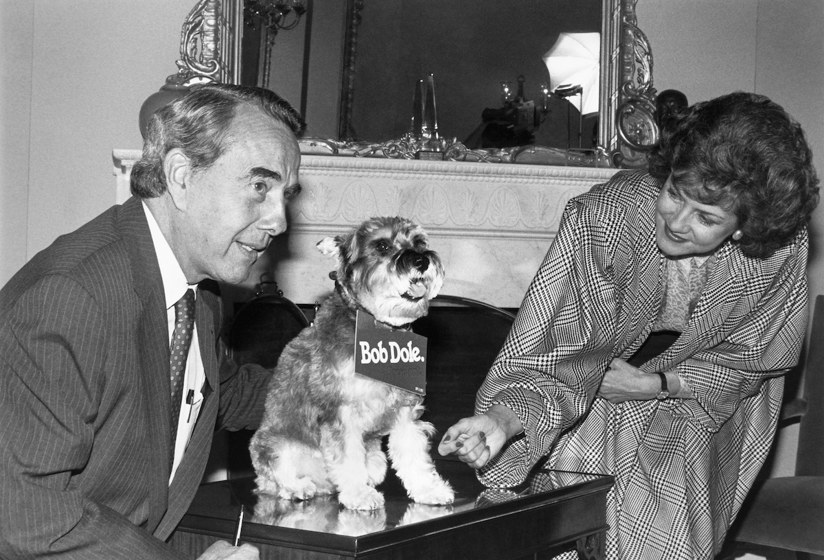 Bob and Elizabeth Dole are seen sitting with their dog. (CQ Roll Call file photo)