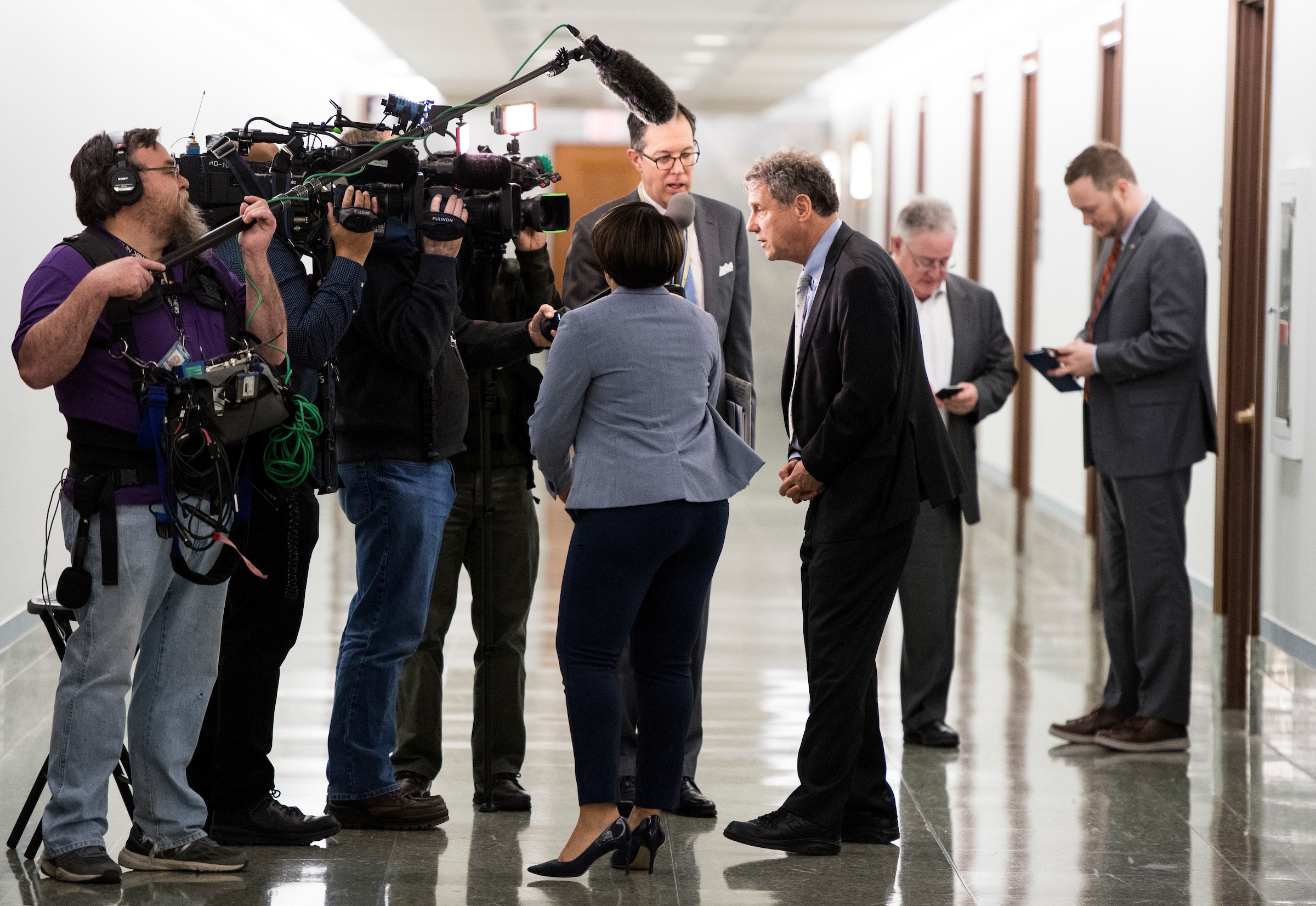 UNITED STATES - MARCH 14: Sen. Sherrod Brown, D-Ohio, stops to speak to the cameras in a hallyway in the Dirksen Senate Office Building on Thursday, March 14, 2019. (Photo By Bill Clark/CQ Roll Call)