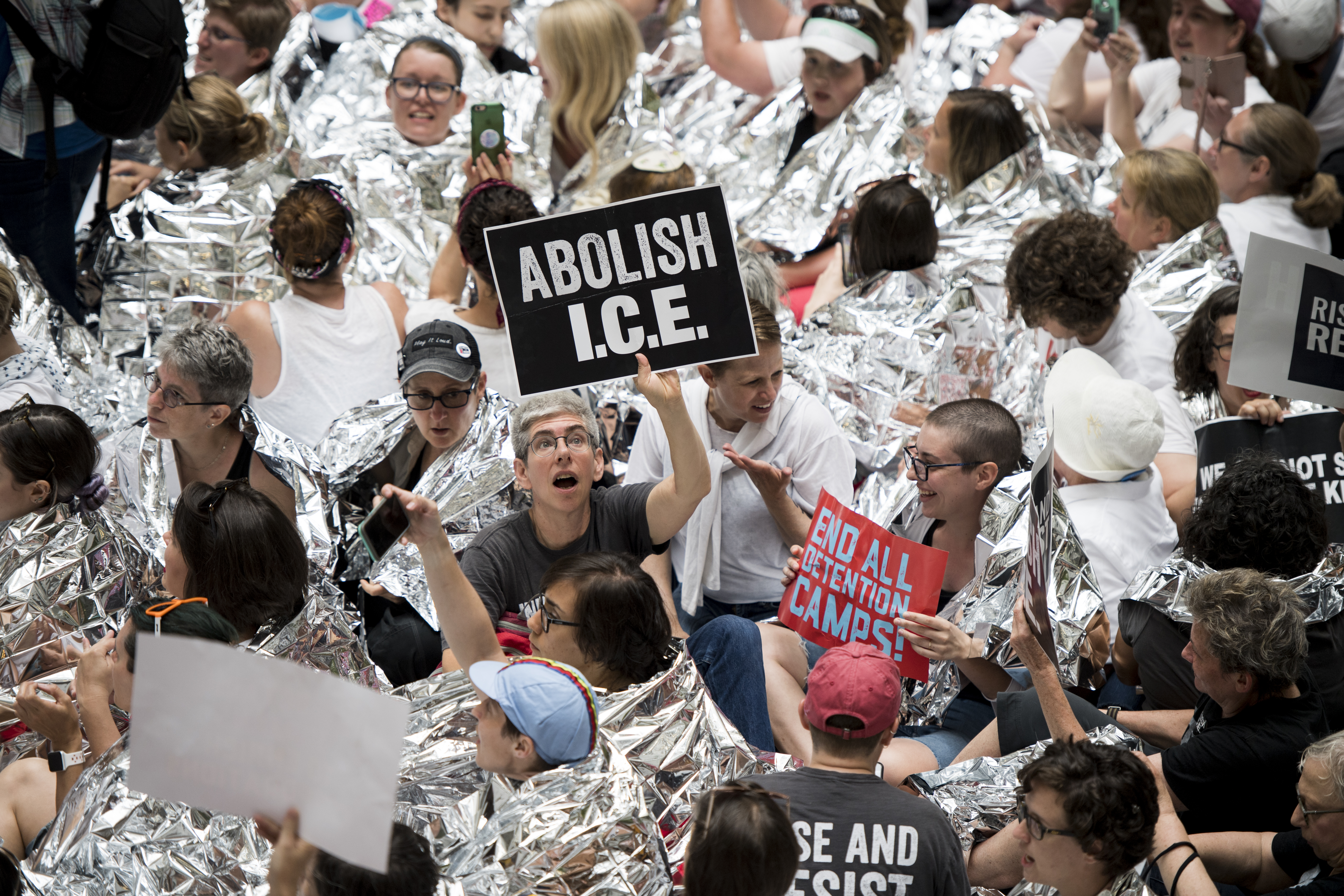 Opponents of President Donald Trump’s immigration policies protest in the atrium of the Hart Building in June 2018. Advocates and successive administrations alike have largely turned to the courts or executive actions to address our immigration problems, with Congress feeling little pressure to intervene, Ramón and Brown write. (Bill Clark/CQ Roll Call file photo)