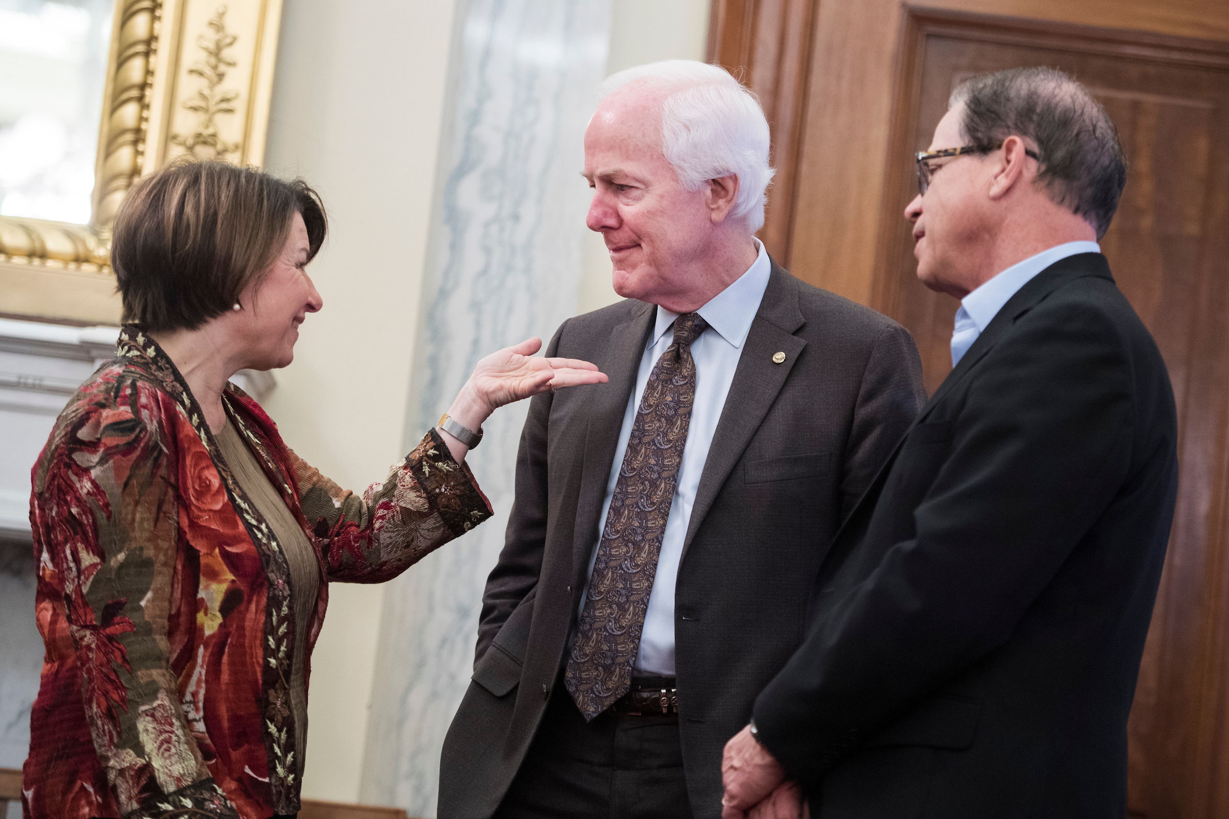 UNITED STATES - MARCH 13: From left, Sens. Amy Klobuchar, D-Minn., John Cornyn, R-Texas, and Mike Braun, R-Ind., attend a Senate Agriculture, Nutrition and Forestry Committee confirmation hearing in Russell Building on Wednesday, March 13, 2019. Heath Tarbert, nominee to be chairman of the Commodity Futures Trading Commission, testified. (Photo By Tom Williams/CQ Roll Call)