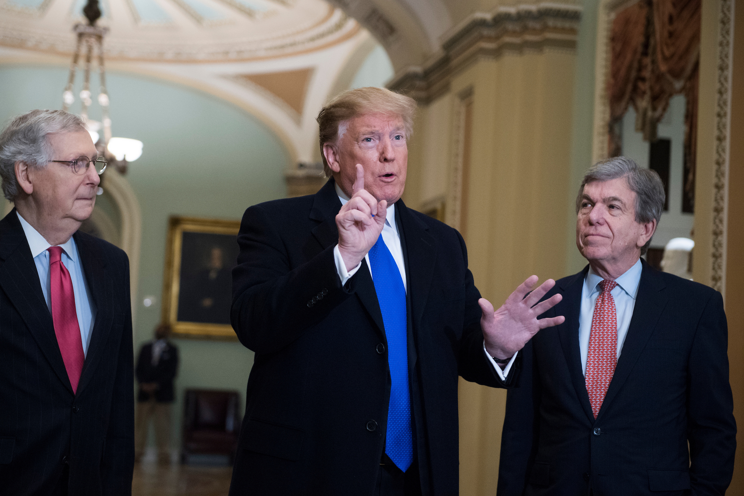 President Donald Trump alongside Senate Majority Leader Mitch McConnell, R-Ky., (left) and Sen. Roy Blunt, R-Mo., talks to the media about Robert S. Mueller III’s report upon arriving for the Senate Republican Policy luncheon in the Capitol on Tuesday. (Tom Williams/CQ Roll Call)