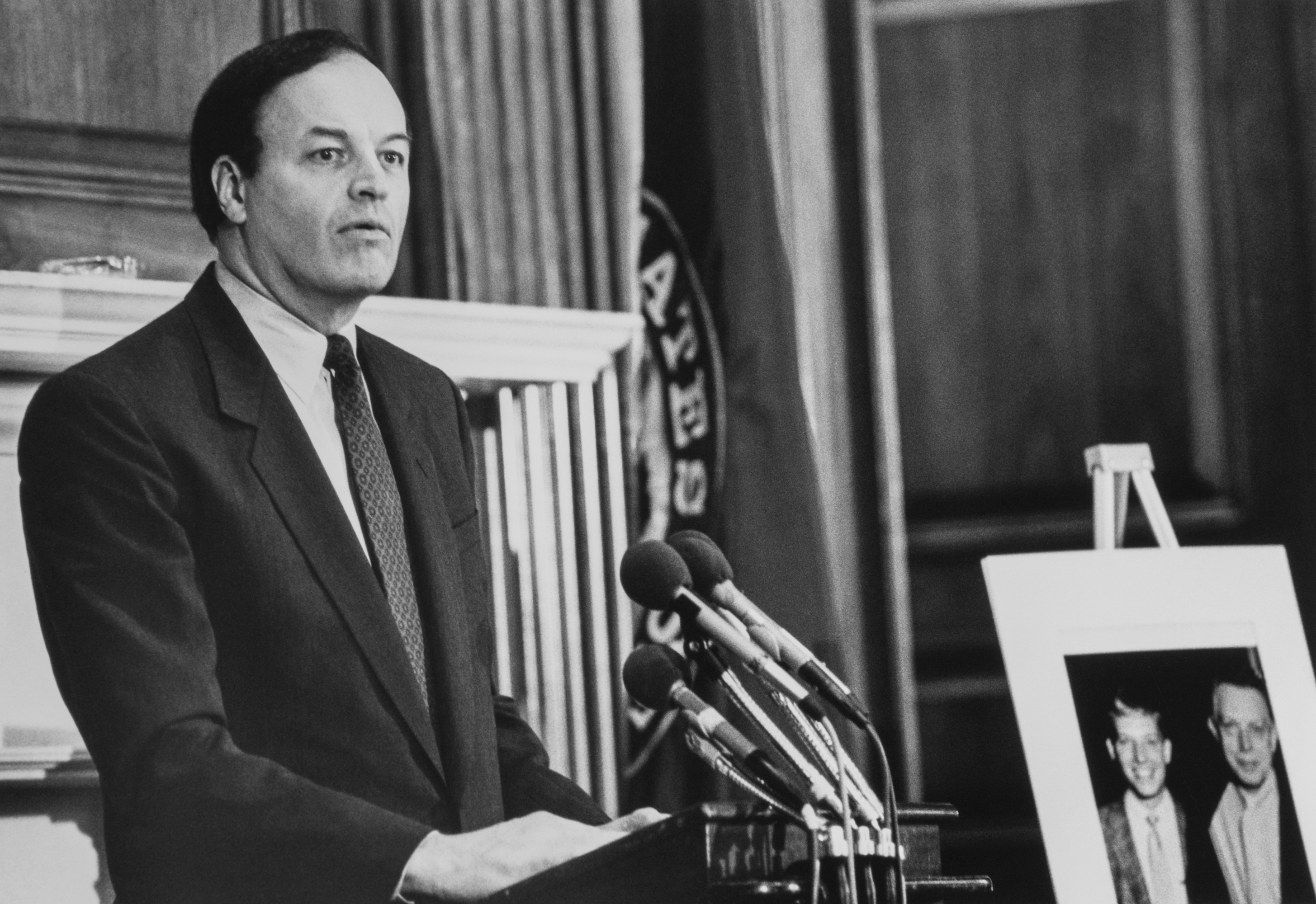 Sen. Richard Shelby, D-Ala., speaks at Tom Barnes memorial service in the Capitol Hill, at right, photo of staffer Tom Barnes and his father. 1992 (Photo by Laura Patterson/CQ Roll Call via Getty Images)