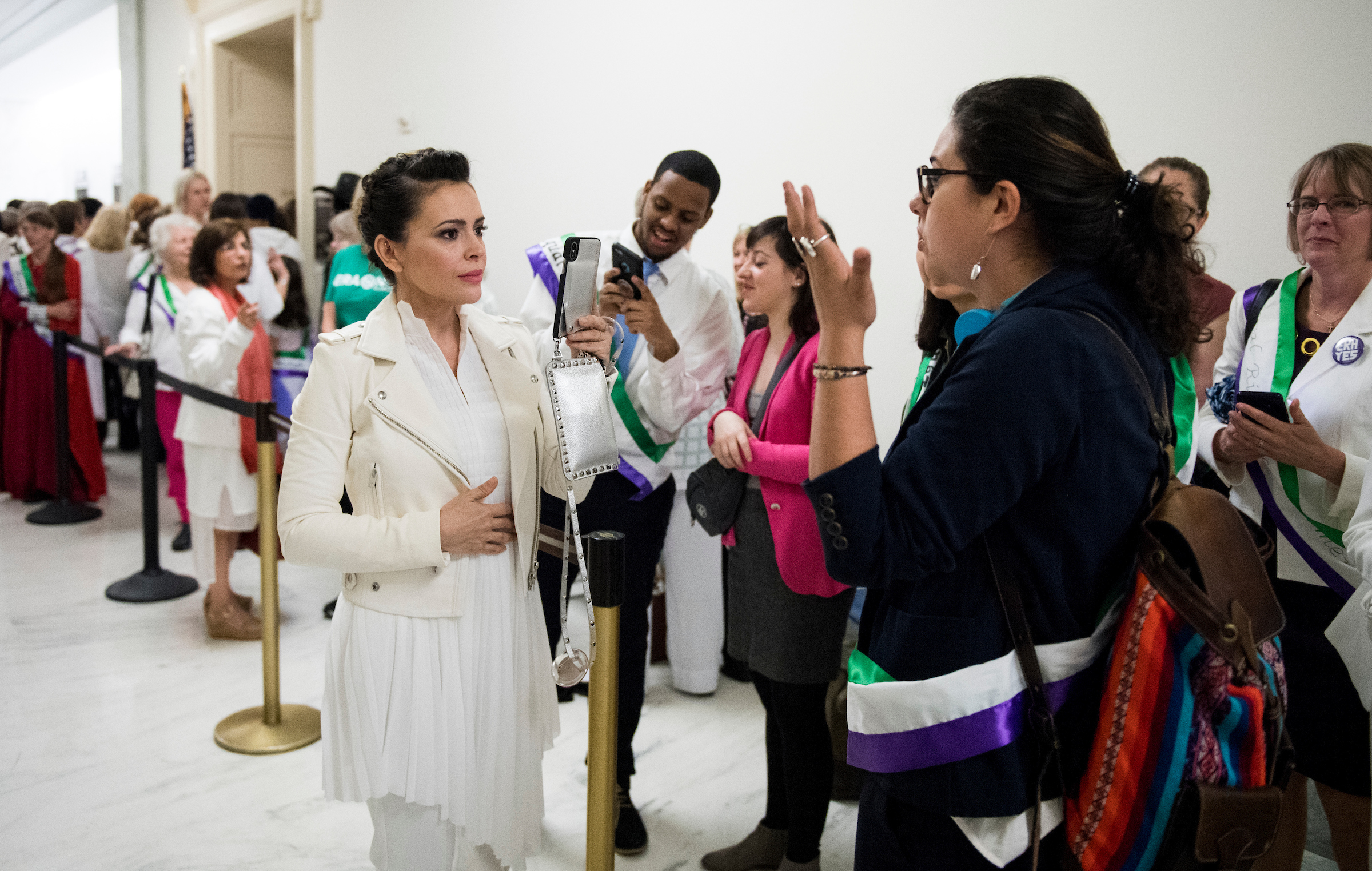 UNITED STATES - APRIL 30: Actress Alyssa Milano, using live twitter video, speaks with ERA activists waiting to enter the House Judiciary Constitution, Civil Rights and Civil Liberties Subcommittee hearing on the Equal Rights Amendment on Tuesday, April 30, 2019. (Photo By Bill Clark/CQ Roll Call)