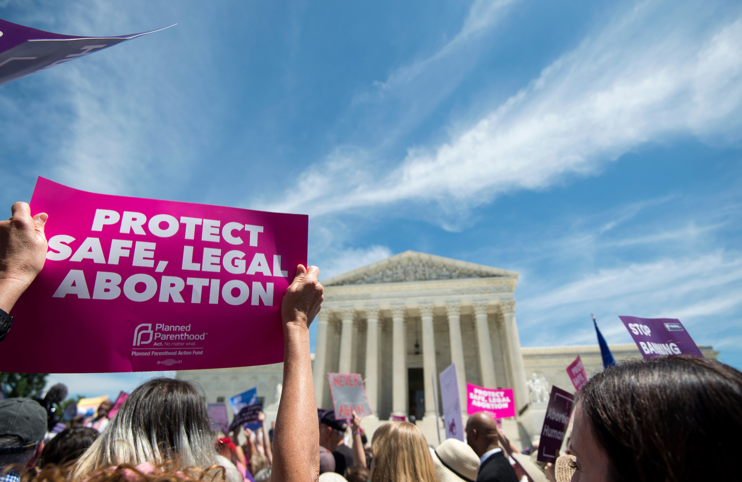 Activists hold up signs at an abortion-rights rally at Supreme Court to protest new state bans on abortion services May 21, 2019. A federal district judge temporarily blocked a Missouri law that would prohibit abortion after eight weeks of pregnancy from taking effect. (Caroline Brehman/CQ Roll Call file photo)