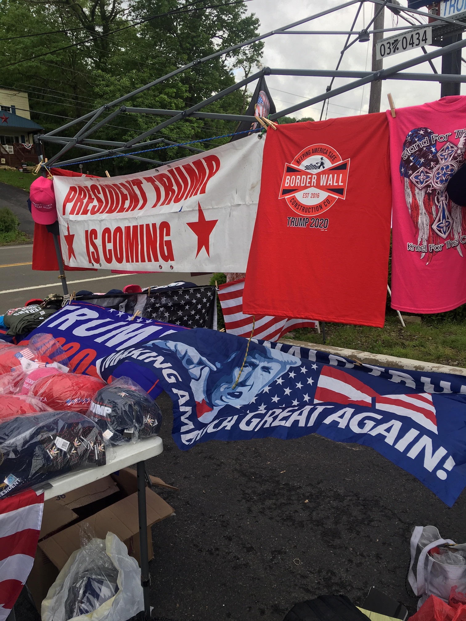 Terri Bruner's pro-Trump merchandise stand greeted passersby in Williamsport ahead of President Trump's Monday evening rally. (John T. Bennett/CQ Roll Call)