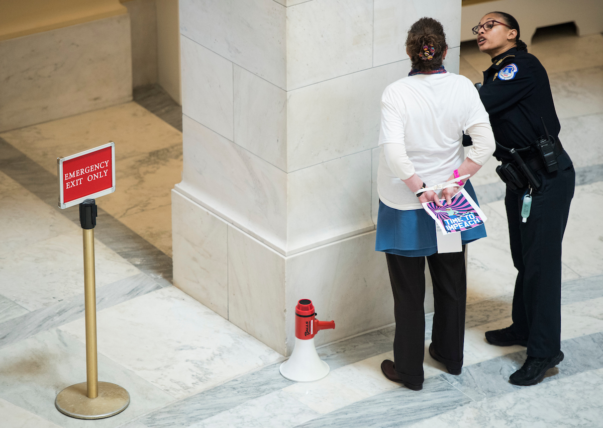 About 20 protesters were arrested while gathered to occupy the rotunda to call for the House to initiate Impeachment hearings. (Photo By Bill Clark/CQ Roll Call)