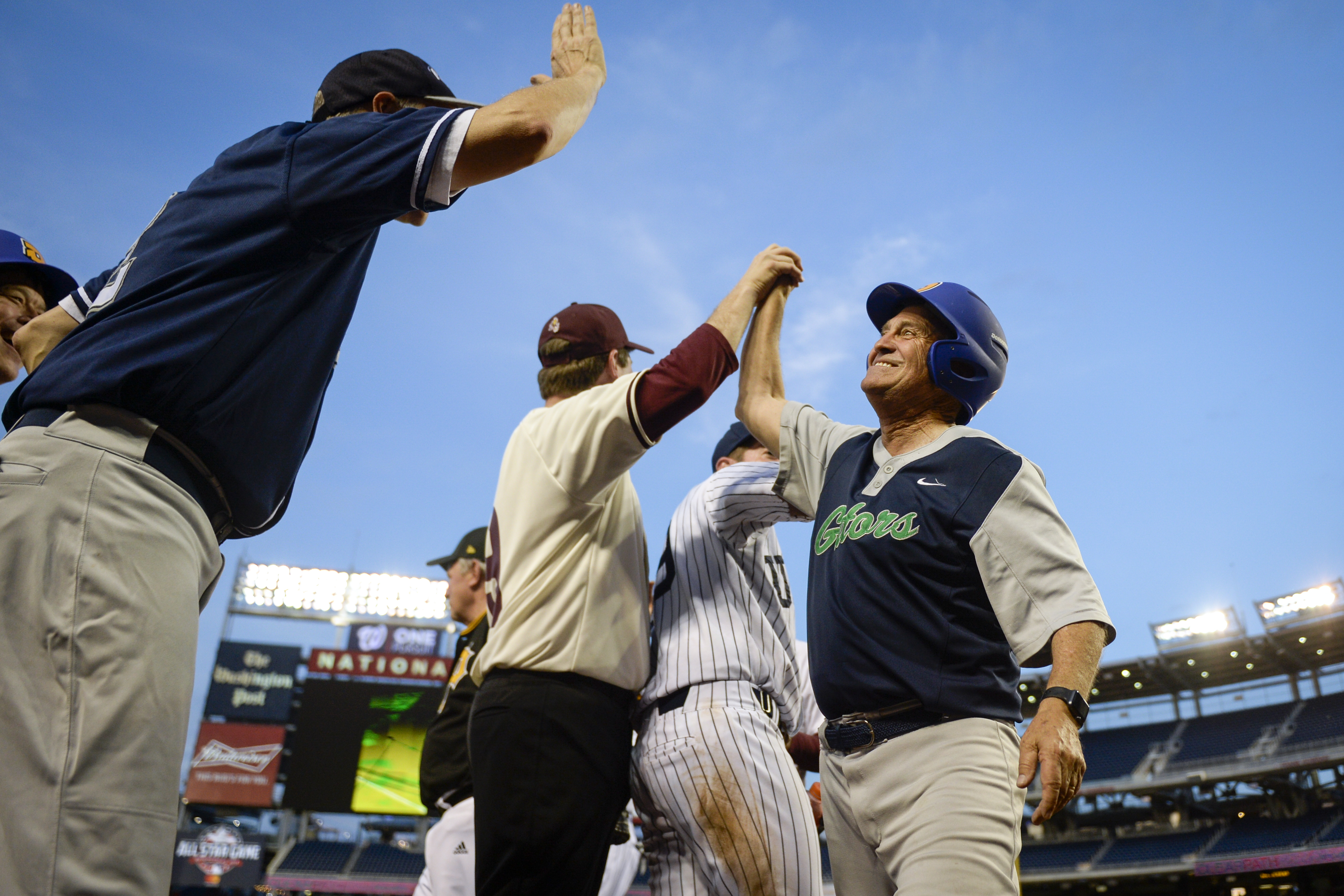 UNITED STATES - JUNE 26: Rep. Ed Permutter, D-Colo., is congratulated by his teammates after scoring a run during the 58th annual Congressional Baseball Game at Nationals Park on Wednesday June 26, 2019. (Photo by Caroline Brehman/CQ Roll Call)
