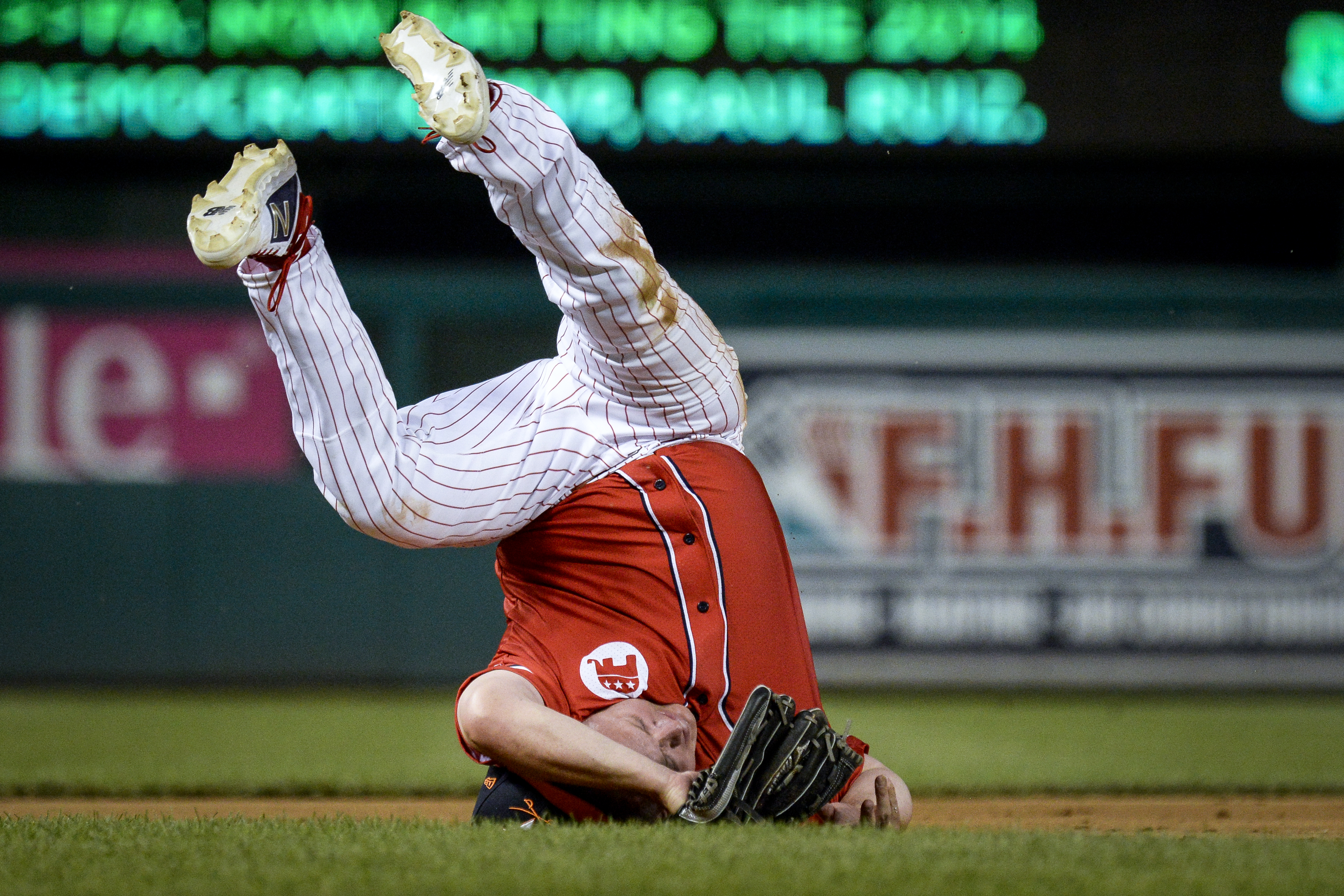 UNITED STATES - JUNE 26: Rep. Denver Riggleman, R-Va., rolls over on his head as he field a ground ball during the 58th annual Congressional Baseball Game at Nationals Park on Wednesday June 26, 2019. (Photo by Caroline Brehman/CQ Roll Call)