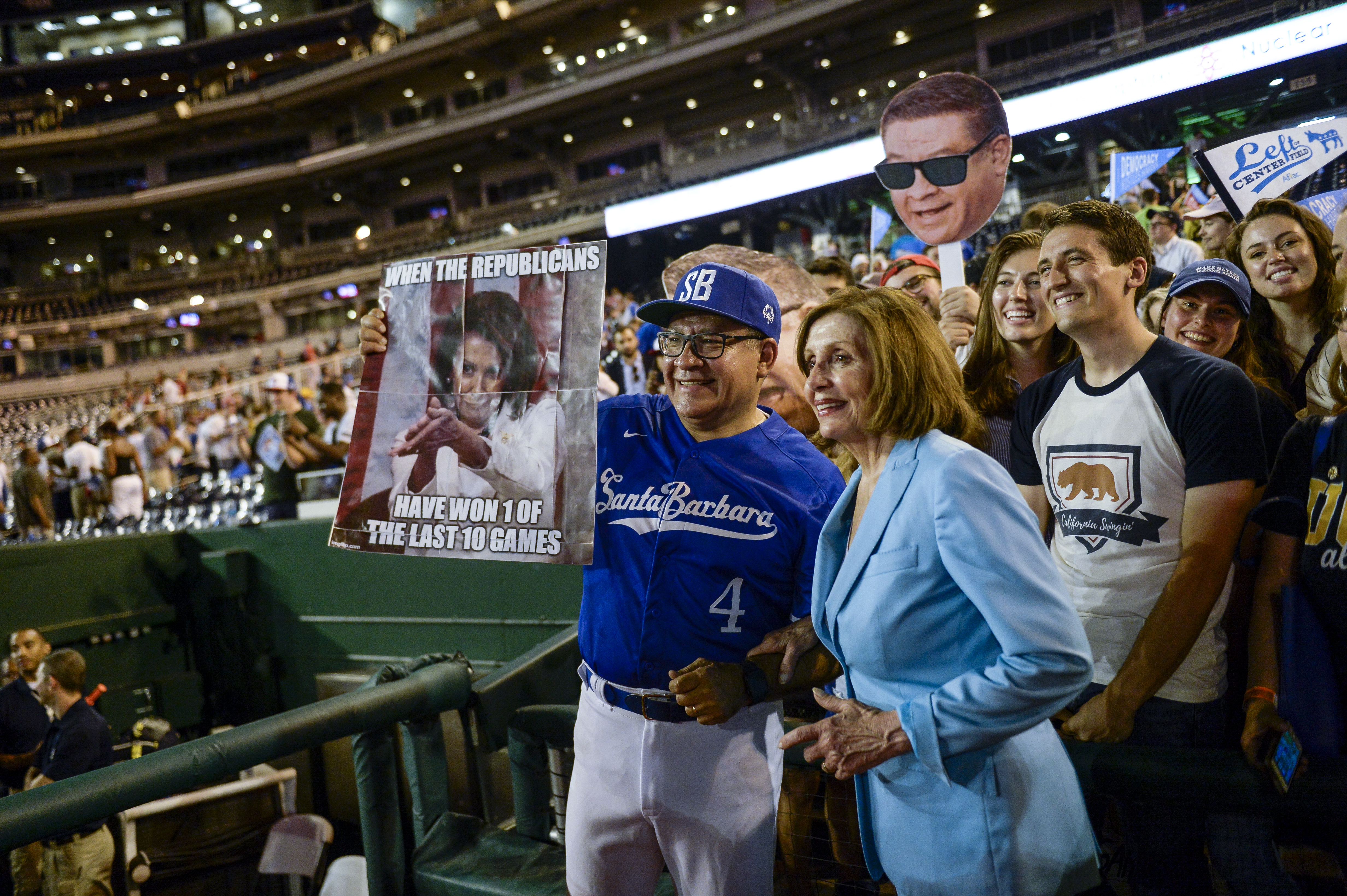 UNITED STATES - JUNE 26: Rep. Salud Carbajal, D-Calif., left, and Speaker of the House Nancy Pelosi, D-Calif., pose with fans after the end of the 58th annual Congressional Baseball Game at Nationals Park on Wednesday June 26, 2019. (Photo by Caroline Brehman/CQ Roll Call)