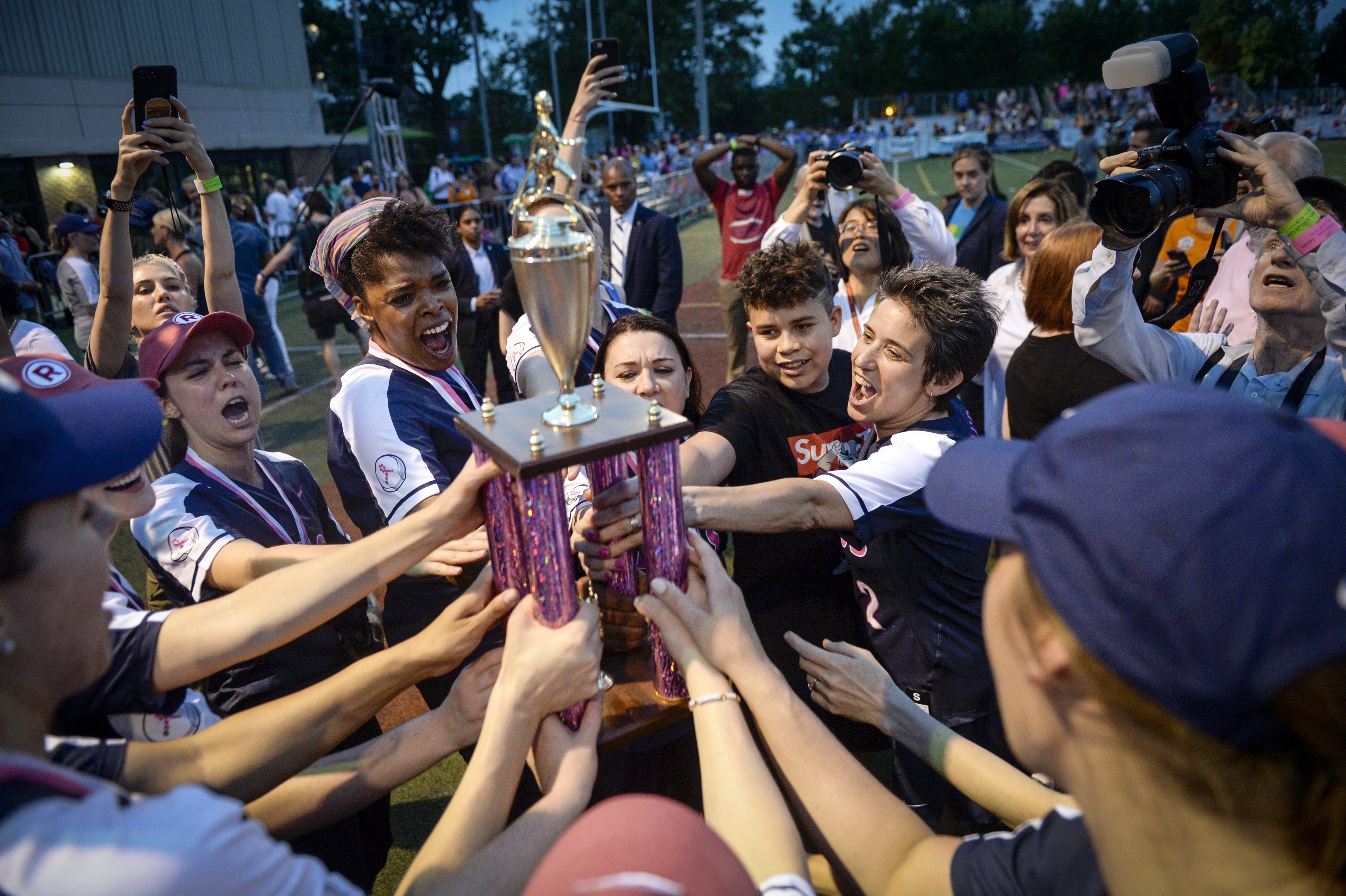 UNITED STATES - JUNE 19: The press softball team holds up a trophy after winning against the Congressional softball team in the in the Congressional Women's Softball Game at Watkins Elementary in Washington on Wednesday June 19, 2019. (Photo by Caroline Brehman/CQ Roll Call)