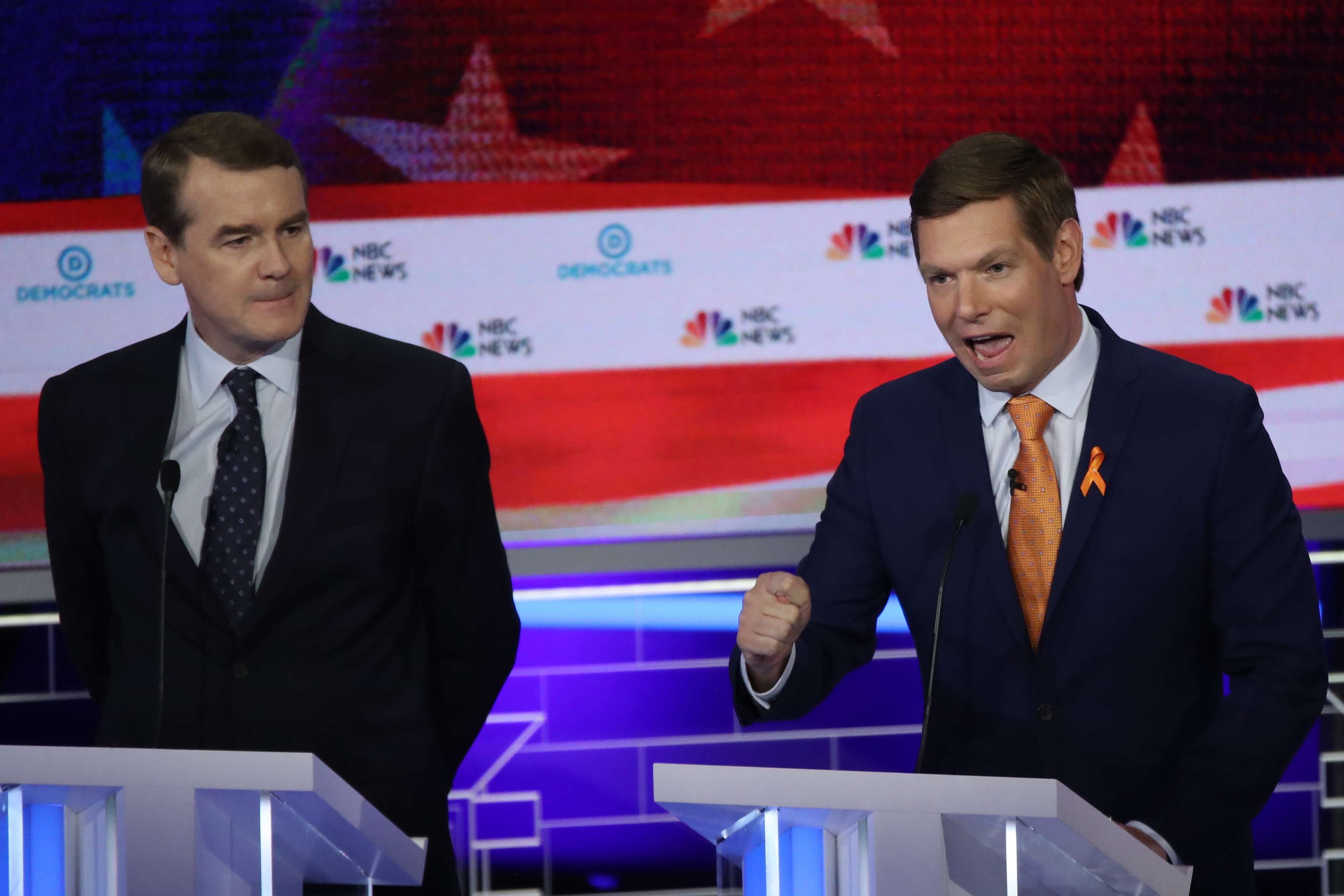 MIAMI, FLORIDA - JUNE 27: Rep. Eric Swalwell (D-CA) speaks as Sen. Michael Bennet (D-CO) looks on during the second night of the first Democratic presidential debate on June 27, 2019 in Miami, Florida. A field of 20 Democratic presidential candidates was split into two groups of 10 for the first debate of the 2020 election, taking place over two nights at Knight Concert Hall of the Adrienne Arsht Center for the Performing Arts of Miami-Dade County, hosted by NBC News, MSNBC, and Telemundo. (Photo by Drew Angerer/Getty Images)