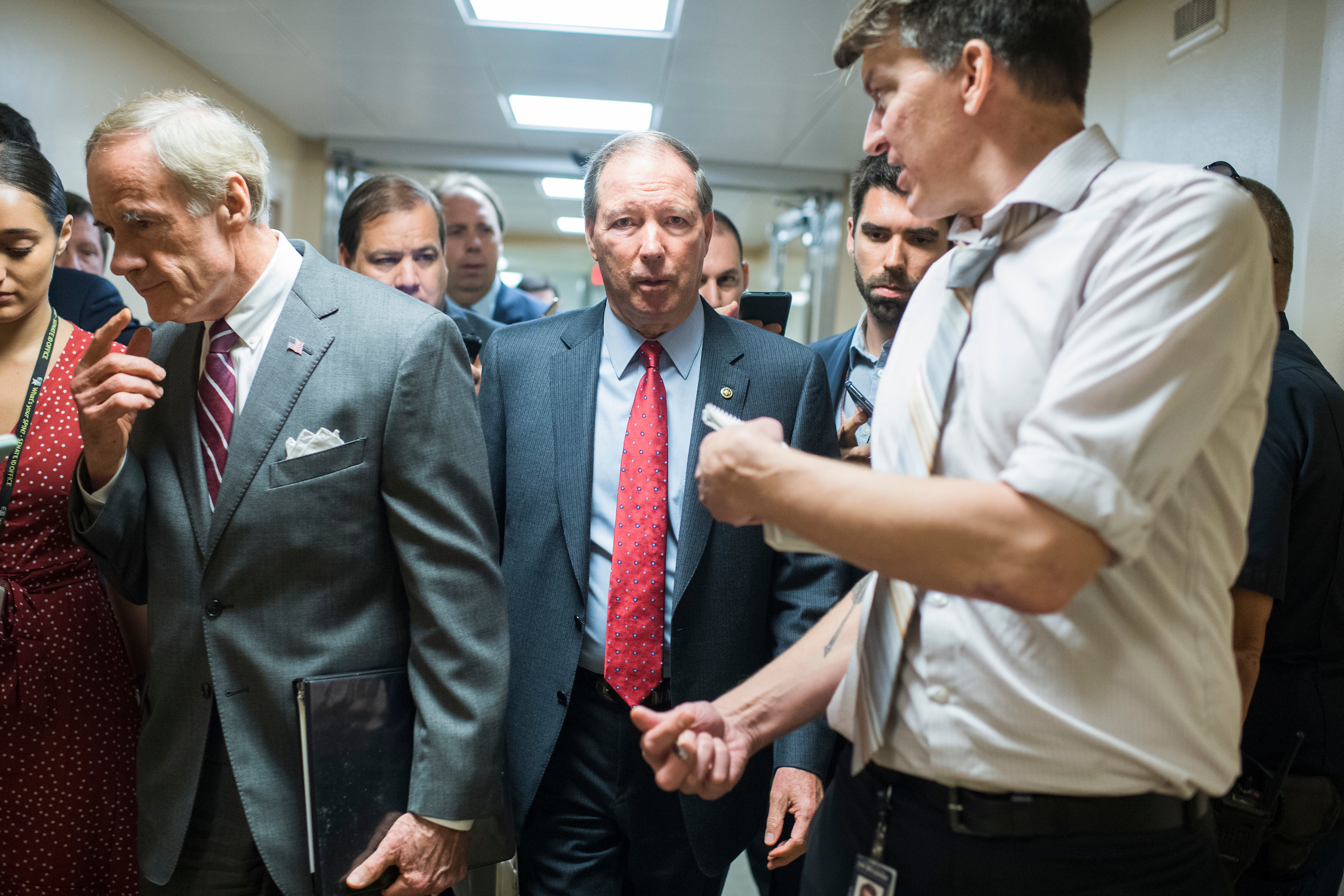 Sens. Tom Udall, D-N.M., right, and Tom Carper, D-Del., talk with reporters in the basement of the Capitol before the Senate Policy luncheons on Tuesday, June 25, 2019. Udall had offered an amendment to the defense authorization bill that would have blocked President Donald Trump from launching a war with Iran without congressional approval. (Tom Williams/CQ Roll Call)