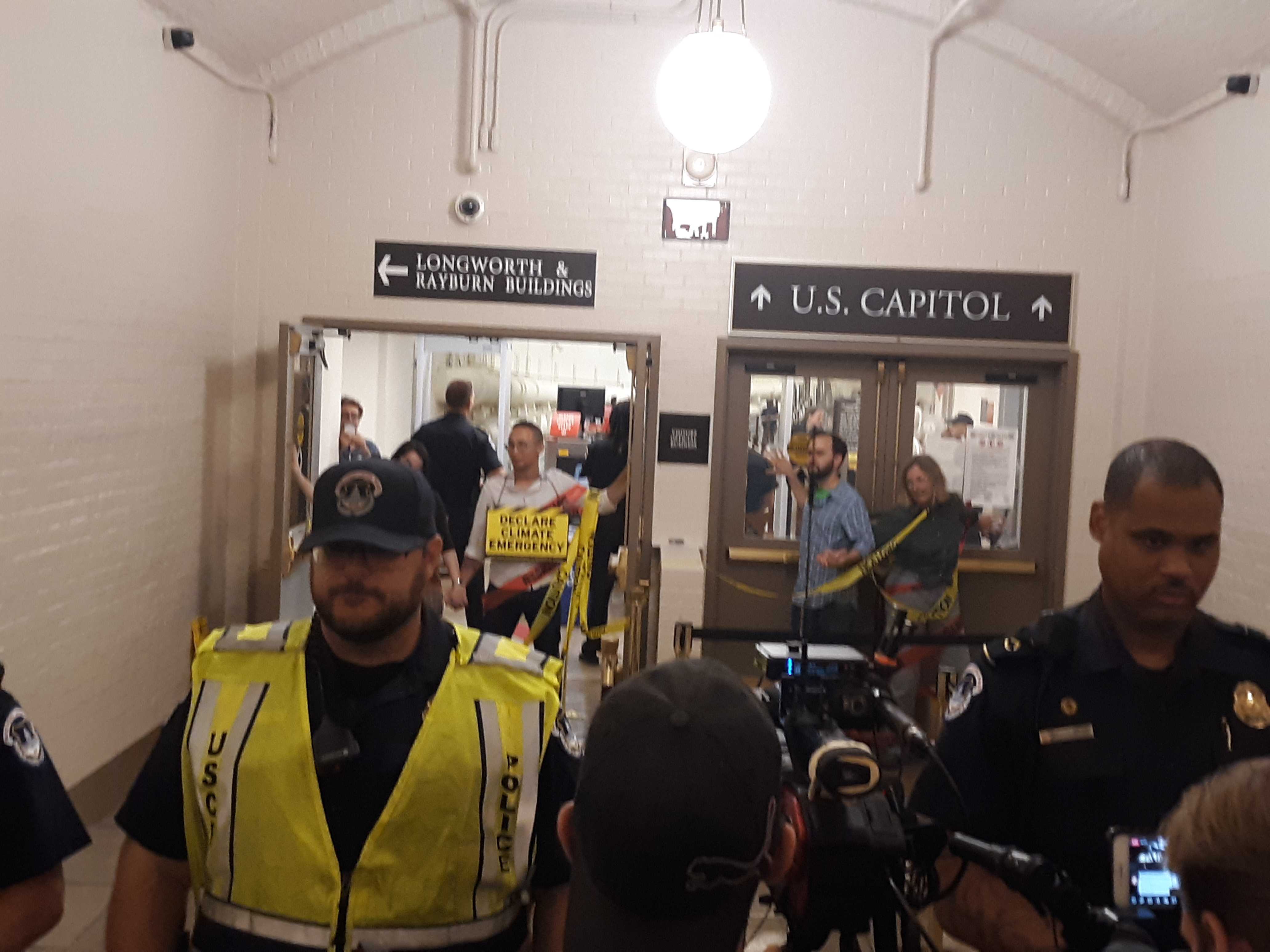 Police block access from the Cannon House Office Building to the Capitol after protesters seeking congressional action on climate change glued themselves to a door Tuesday night, but House members found other routes to the chamber. (Doug Sword/CQ Roll Call)