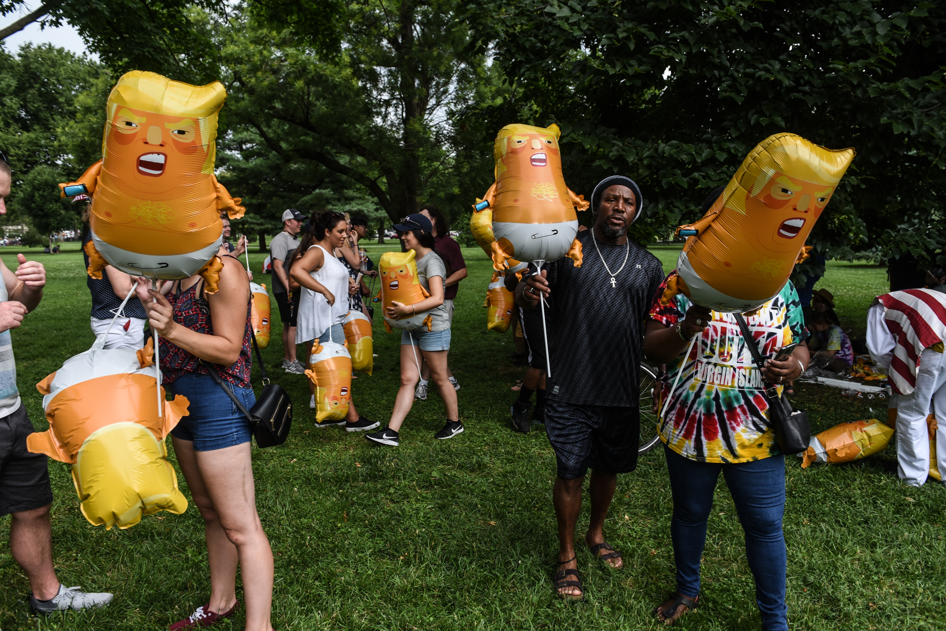 People blow up ‘Trump Baby’ balloons during Fourth of July festivities on the National Mall on Thursday before President Trump held a ’Salute to America’ program featuring military flyovers. (Stephanie Keith/Getty Images)