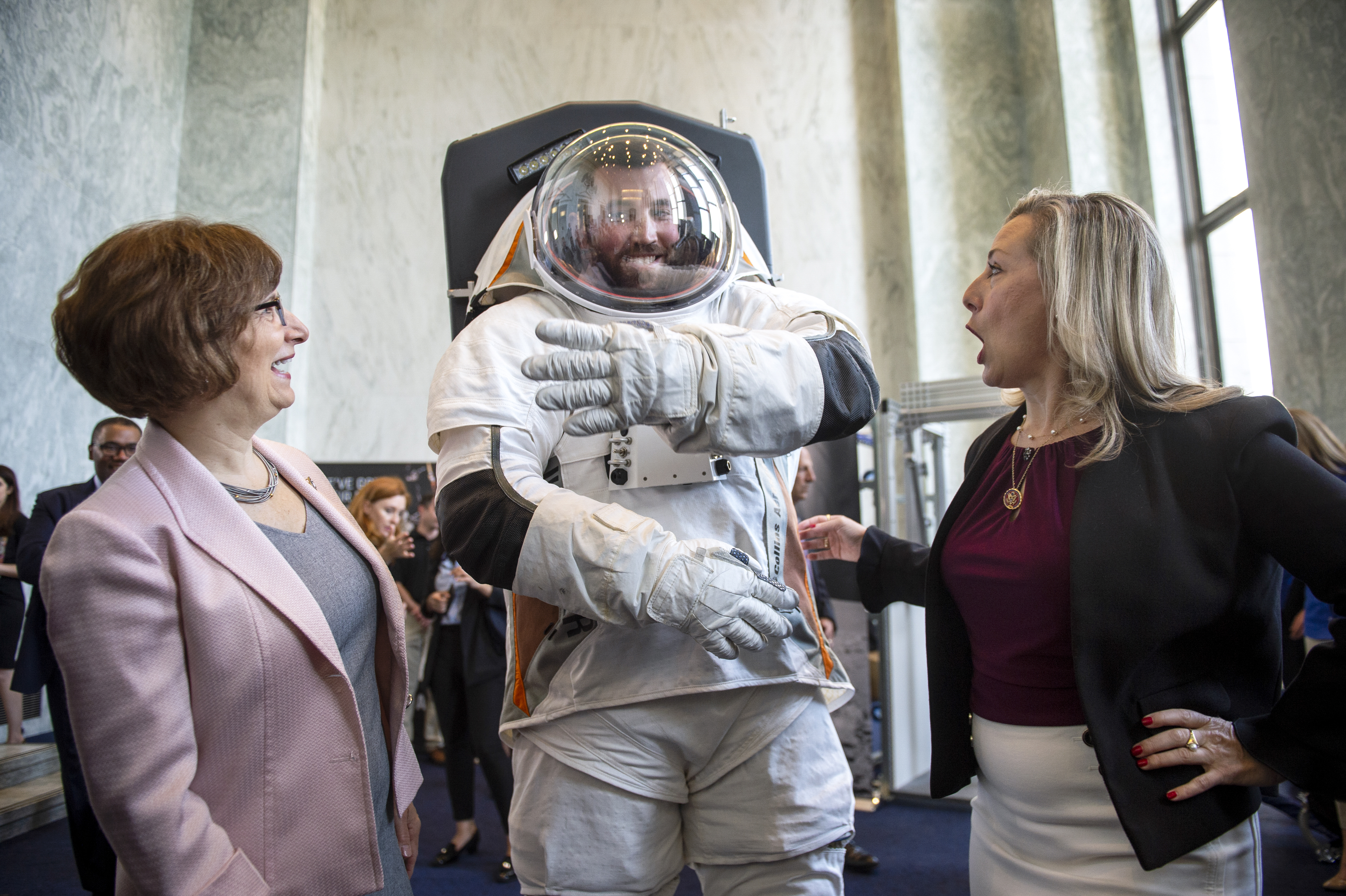 UNITED STATES - JULY 25: Rep. Suzanne Bonamici, D-Ore., left, and Space Subcommittee Chair Rep. Kendra Horn, D-Okla., talk with a man modeling a possible prototype of the future suit for the upcoming mission to the moon in the Rayburn Building in Washington on Thursday July 25, 2019. (Photo by Caroline Brehman/CQ Roll Call)
